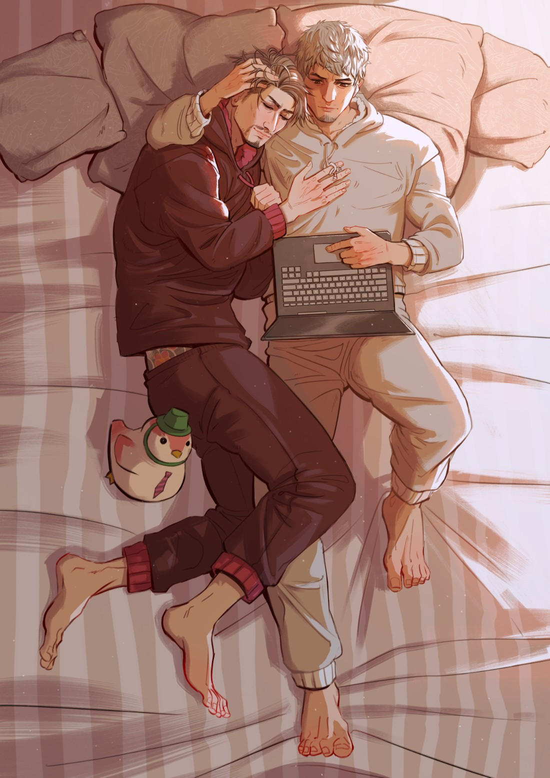 And overhead view of Kiryu and Majima dressed in cozy pajamas and cuddled up together in bed. Majima has his head on Kiryu's shoulder while Kiryu absently pets his hair and watches a video on his laptop.