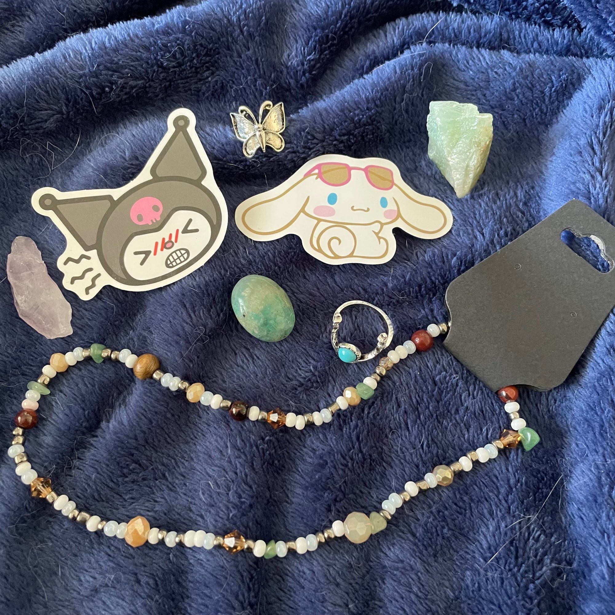 kuromi and cinnamoroll stickers, 3 crystals, 2 rings, and a beaded necklace