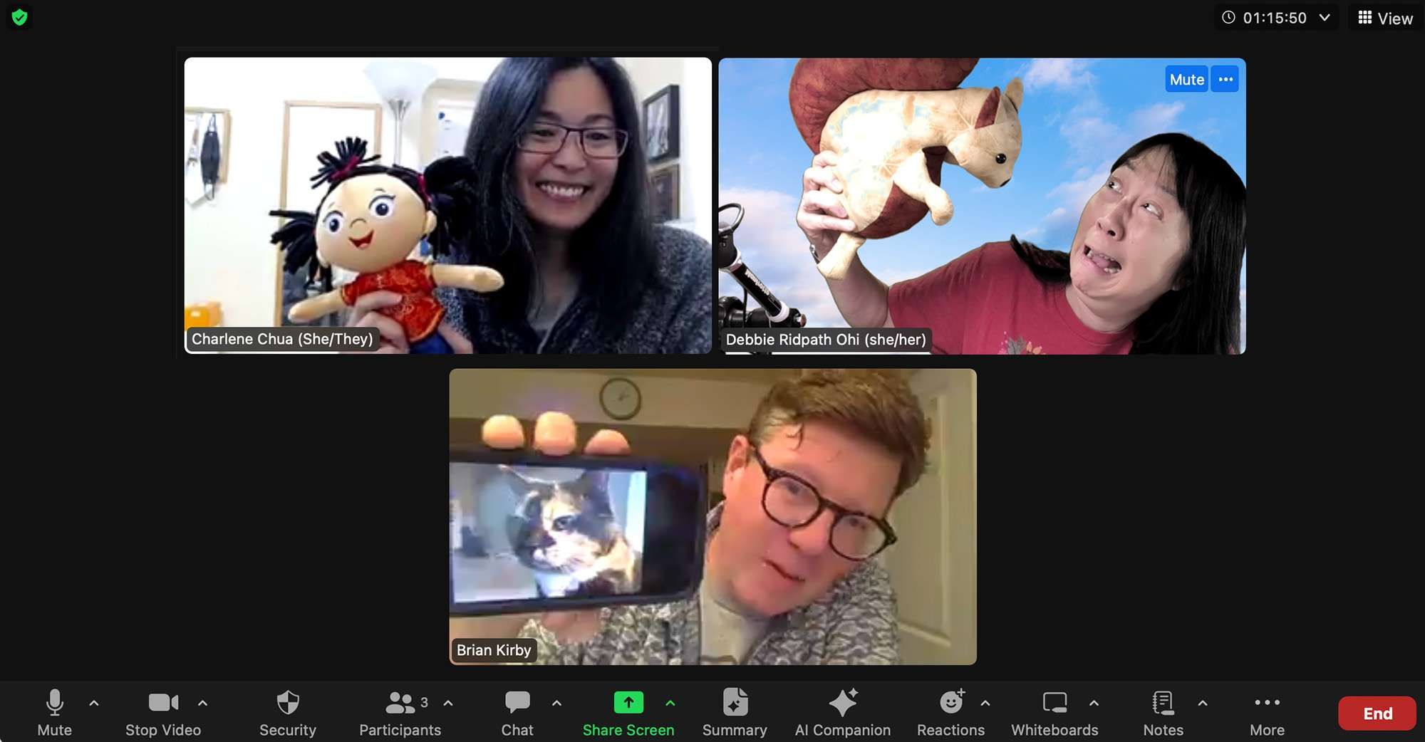 Three people having silly fun in a video call, each holding an object. One screen shows a woman holding a doll in a red dress. Another screen shows a woman pretending to be scared of a toy squirrel. Another screen shows a man holding up a screen that depicts a cat.