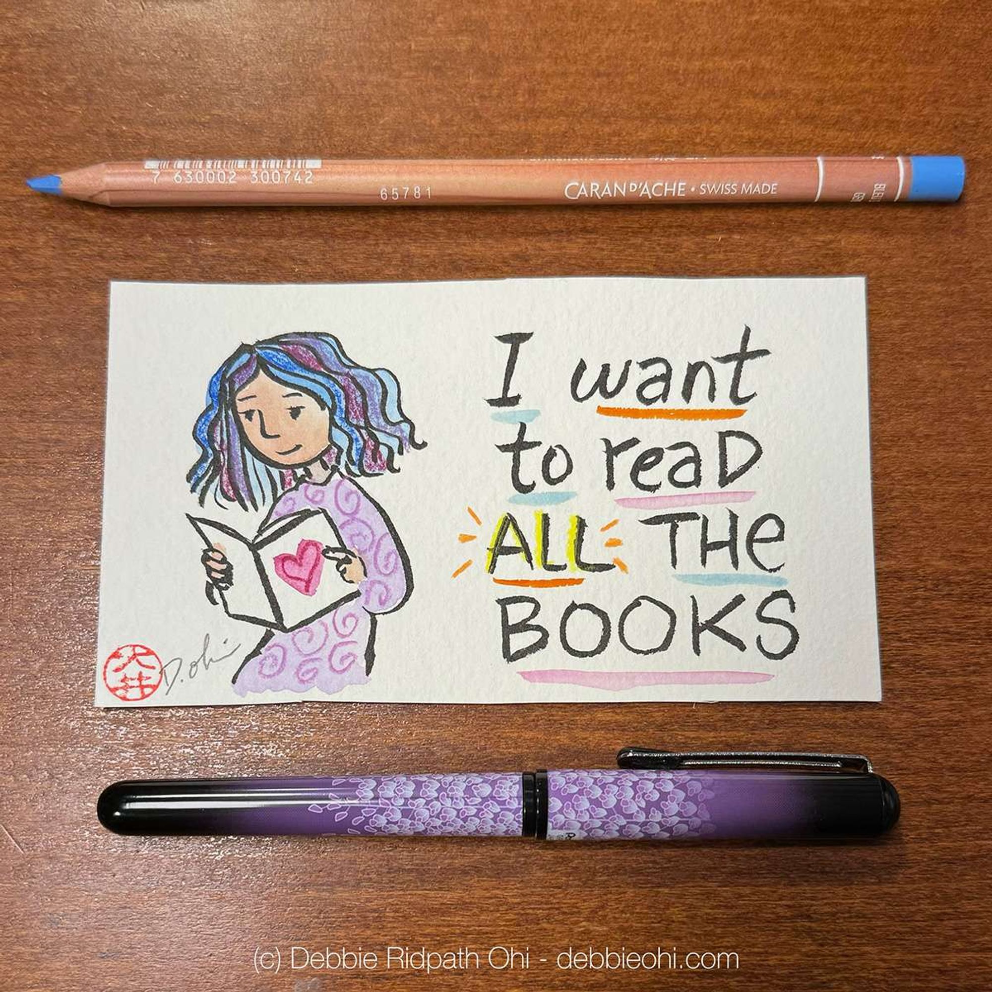 Photo of original art whose text reads "I want to read ALL the books." Illustration shows a woman reading a book. Art tools showing: blue colored pencil, purple pen.