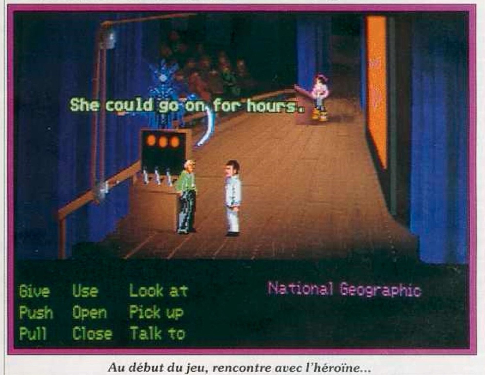 A screenshot of a very early build of Indiana Jones and the Fate of Atlantis, showing an early version of the backstage of Sophia's theater in New York City. The stagehand's sprite is drawn in an early palette that looks very much like EGA, and has slightly different details like a green shirt. Indy's suit-wearing sprite is also EGA here, since it's a placeholder borrowed from the 16-color Last Crusade game. Plus, Sophia's temporary sprite is Elaine from Monkey Island 1 EGA, which might be one reason why her formal outfit in the final game has a purple shirt and black skirt, like the colors of Elaine's outfit. The Nur-Ab-Sal puppet has a temporary sprite of Chaos holding the Great Scythe from Loom. In the background, the slides for Sophia's lecture are not yet drawn, with a solid red placeholder background there instead. The GUI has nine green verbs on a solid black background, and a text inventory which includes a copy of "National Geographic" instead of "National Archaeology".