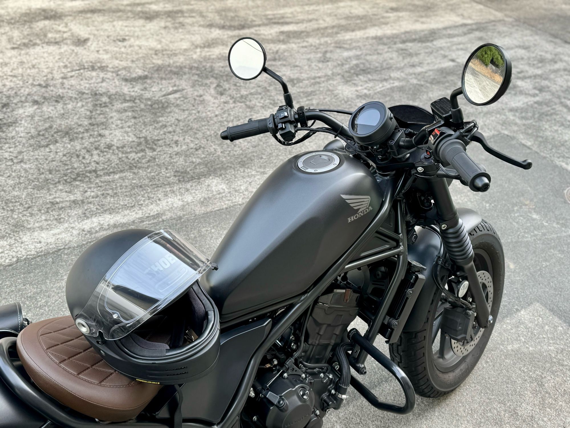 私の愛車(オートバイ)の写真です。HONDA Rebel 250 S Editionというオートバイです。シートにヘルメットが置いてあります。ヘルメットはSHOEIのGlamsterです。