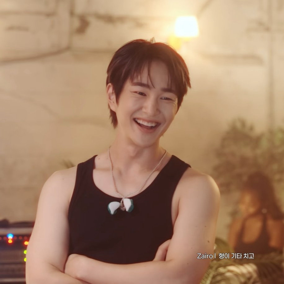 Onew beaming black tank top suns out guns out bathed in golden light