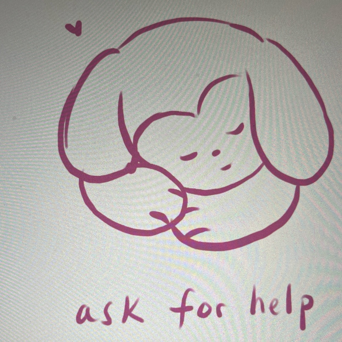 Photo of an iPad screen with a doodle of a cartoon sleeping lop eared bunny. The text underneath reads, “ask for help”. On the top left, there is a small heart.