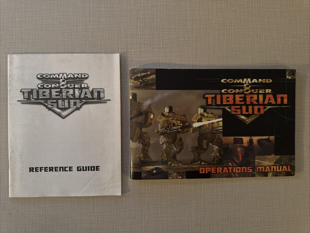 A picture of 2 books, one is a Command and Conquer Operations Manual with drawings of the chevron logo and giant walking robots, and the other plainer is a Reference Guide