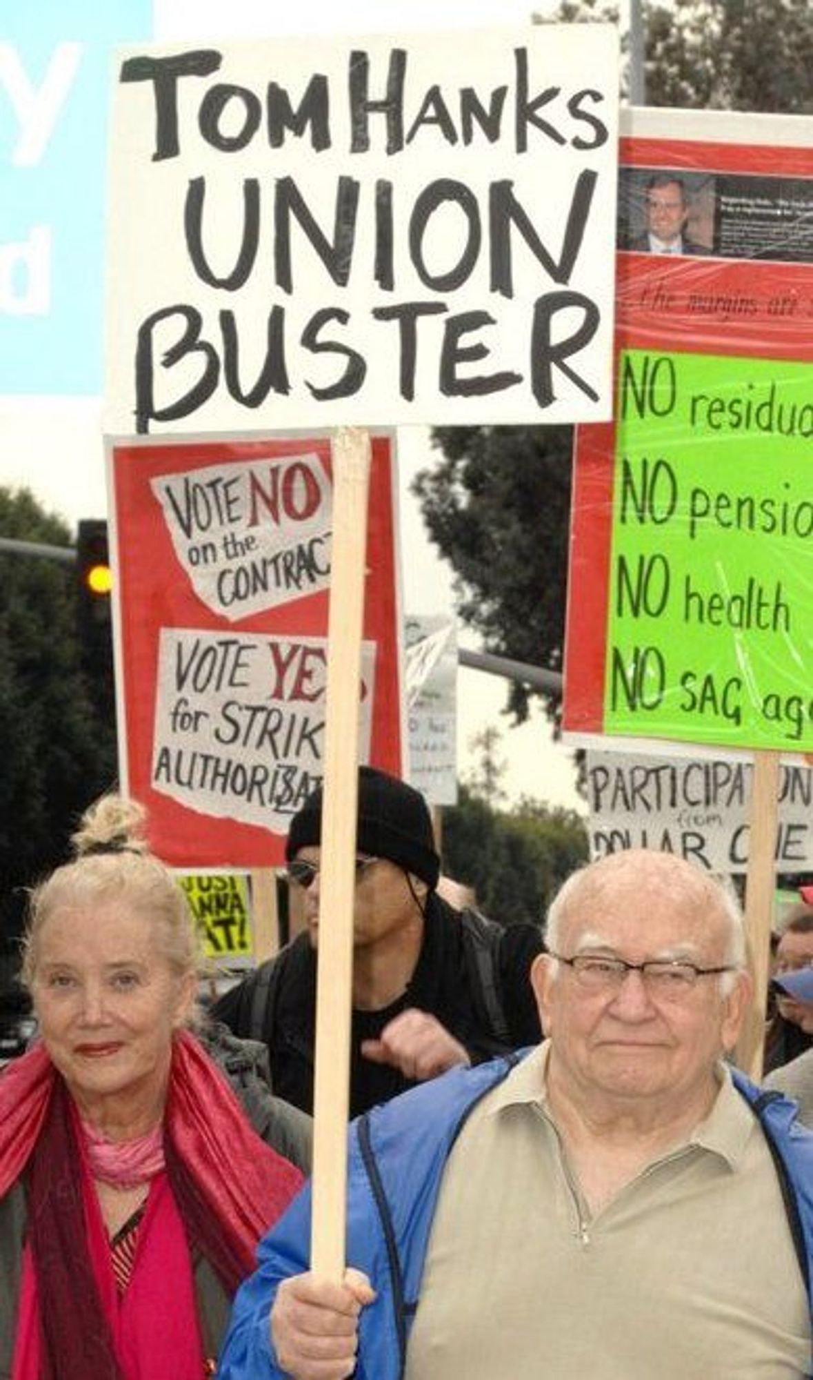 Ed Asner holding sign which reads: TOM HANKS UNION BUSTER