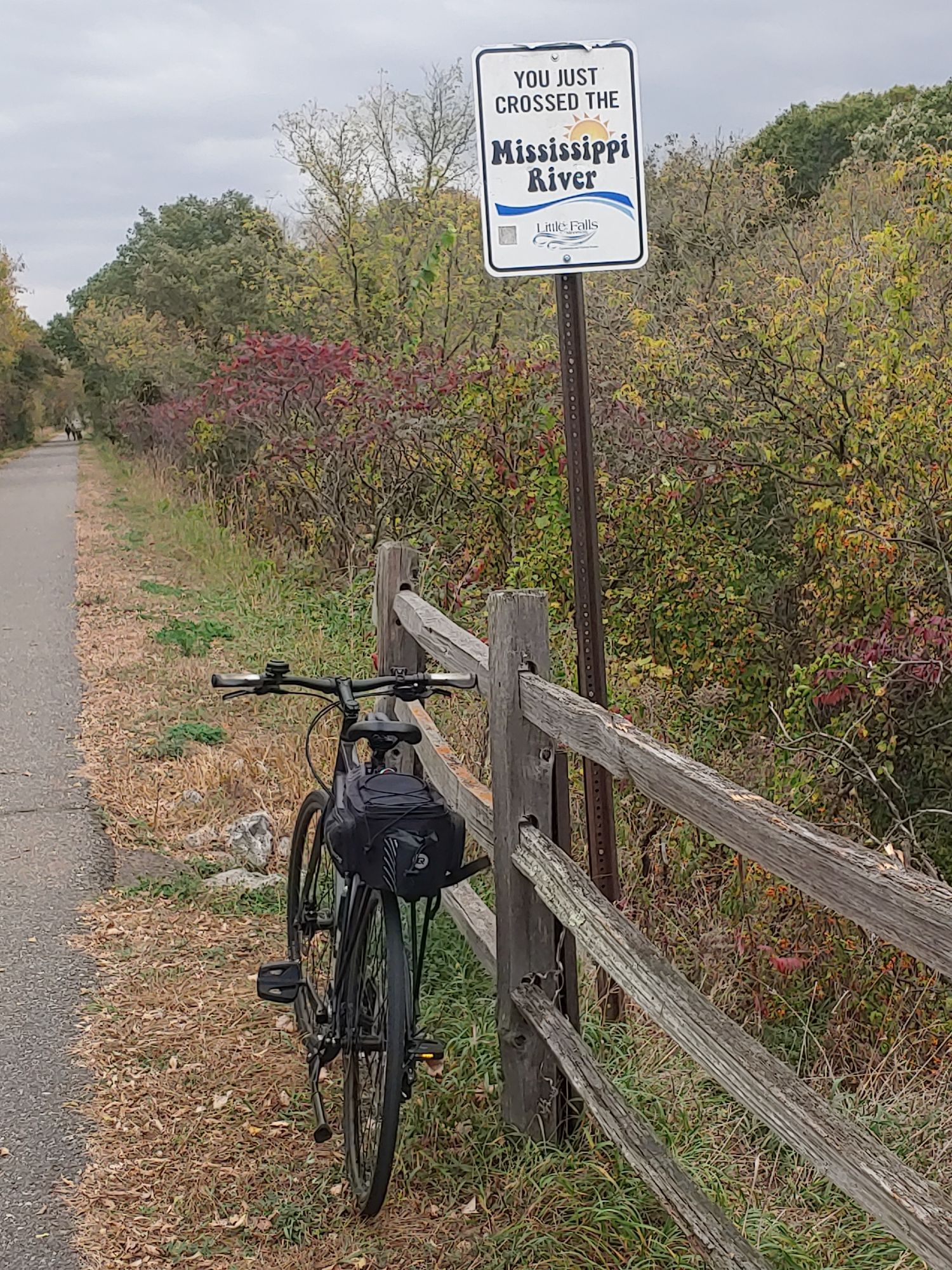 Bicycle parked by sign which reads, "YOU JUST CROSSED THE Mississippi River"