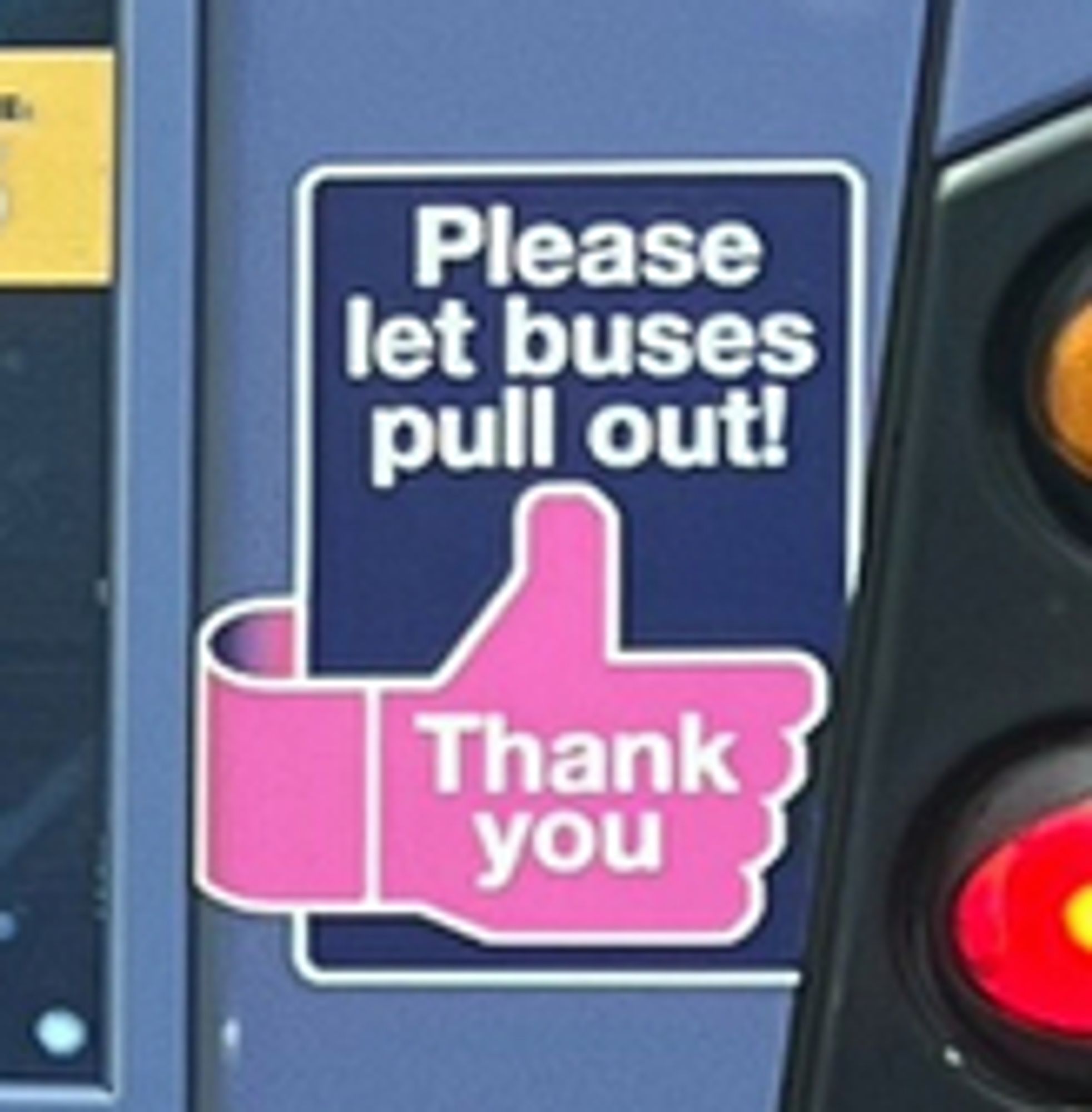 A sticker on a bus asking the driver behind to "Please let buses pull out!"

Below is a pink thumb with the words Thank you on.