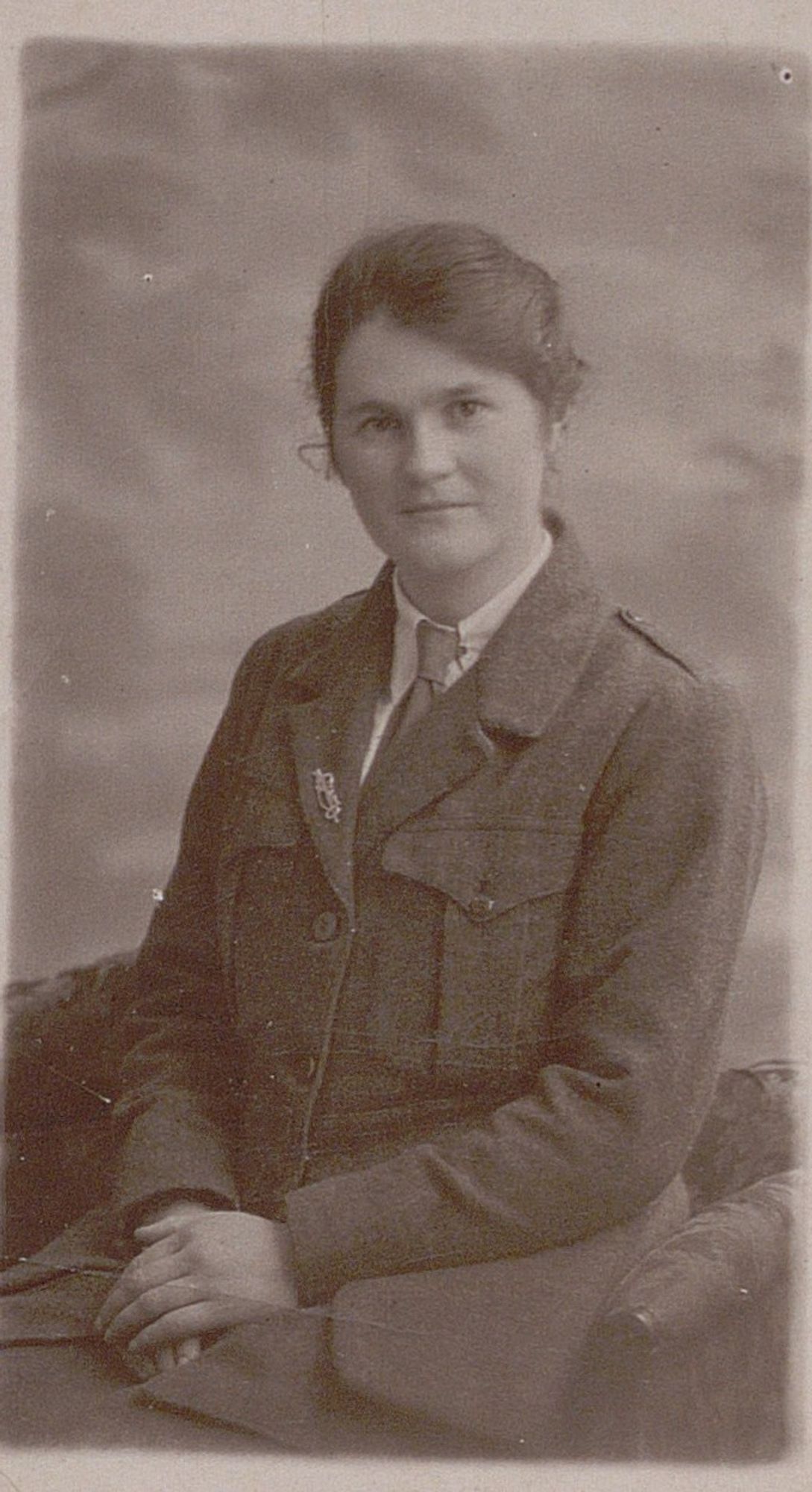 Kathleen Boland is wearing uniform and is seated facing the camera with her hands on her lap.