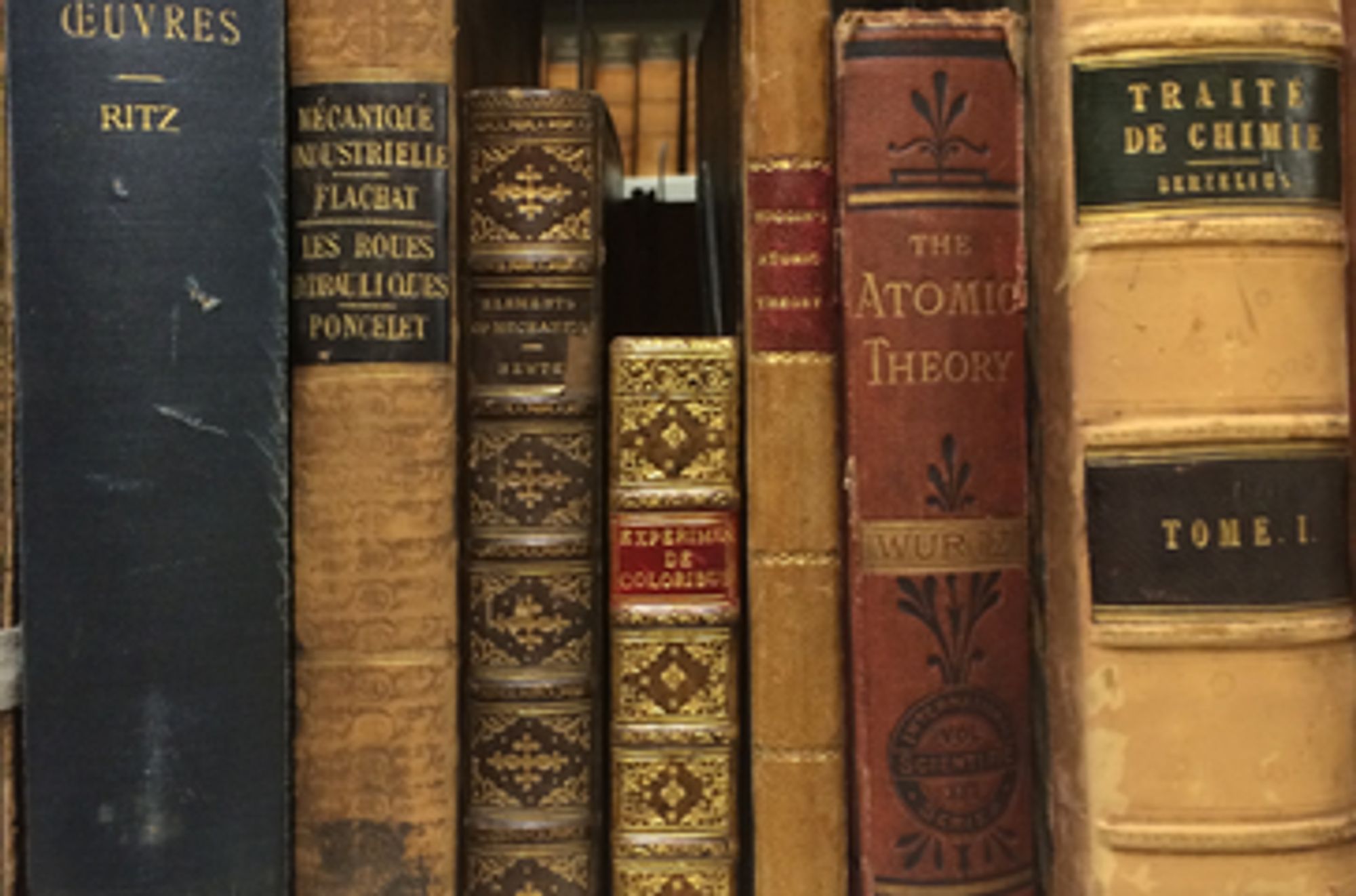 Spines of old books. The spines are richly decorated with gilt and leather.