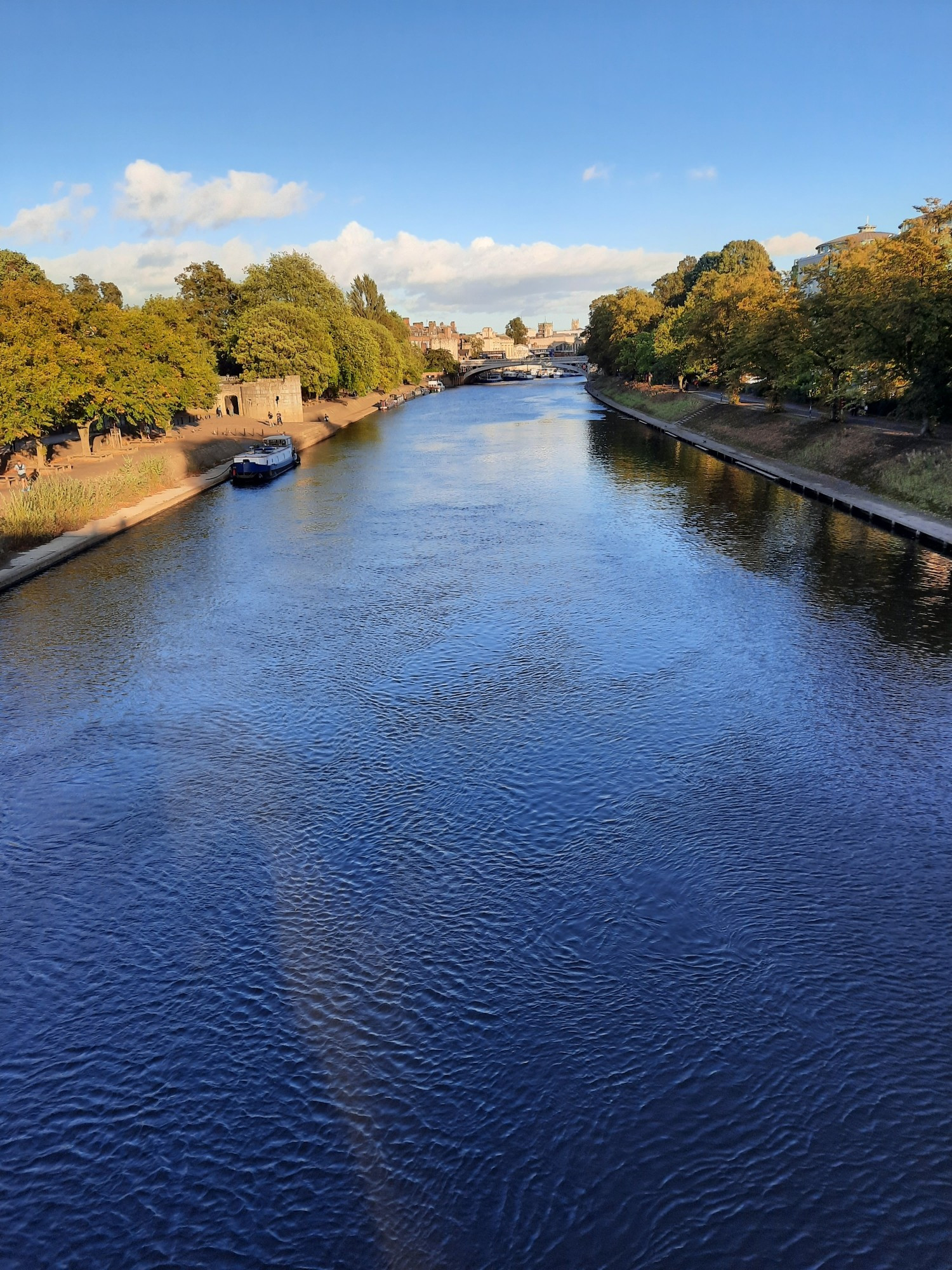 River Ouse York. View from Scarborough Bridge looking along a blue river towards Lendal Bridge.