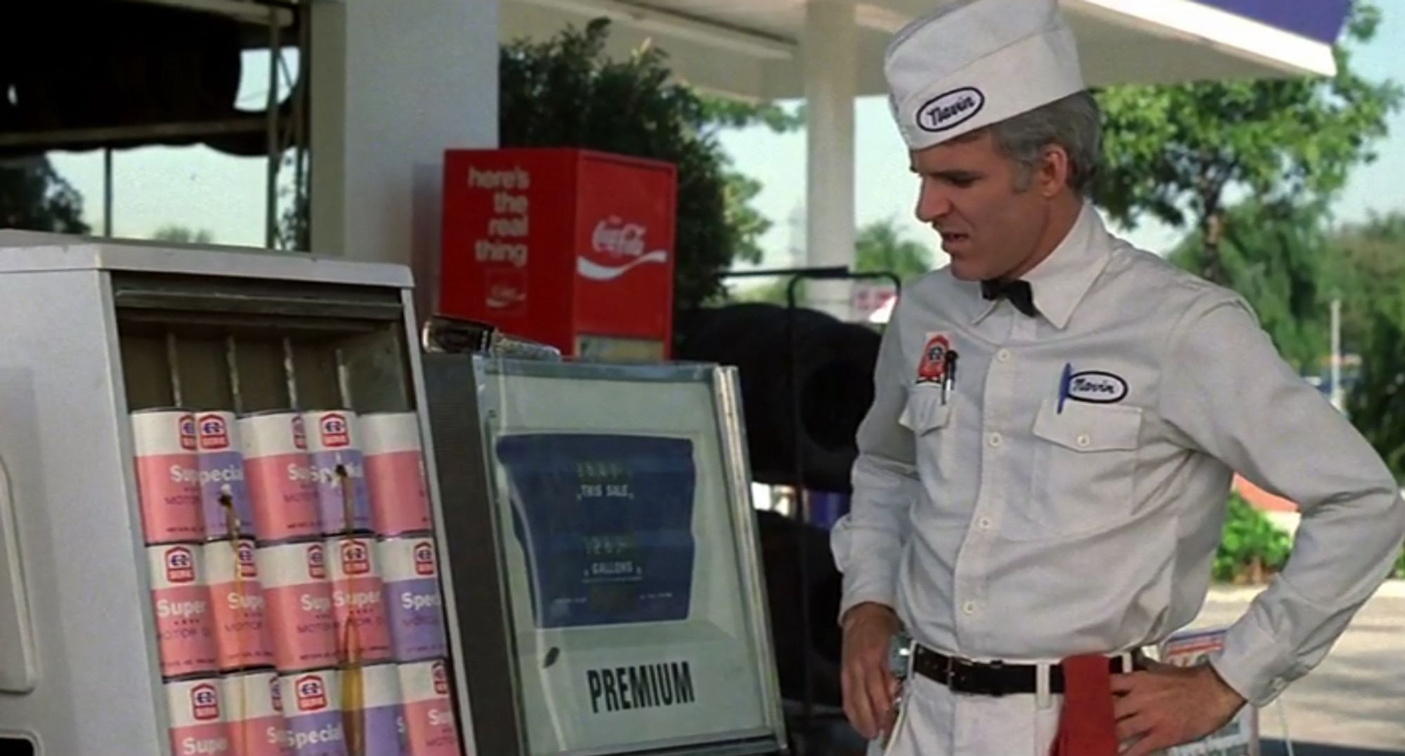 Navin Johnson (Steve Martin), a naive young gas station attendant, looks in shock at oil cans full of bullet holes, thinking an assassin hates the cans.