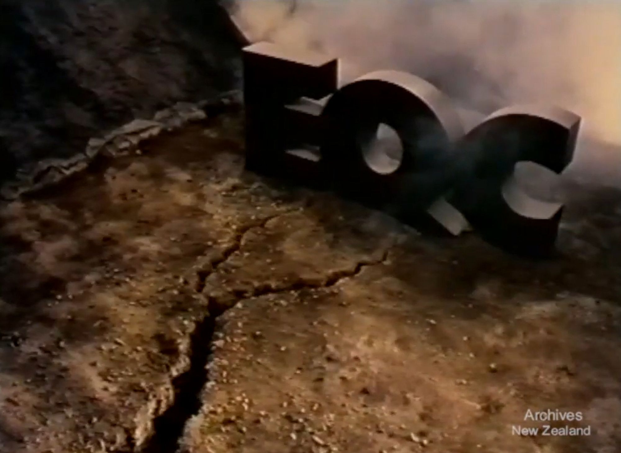 Still from an EQC TV ad showing cracking ground in front of the letters EQC.