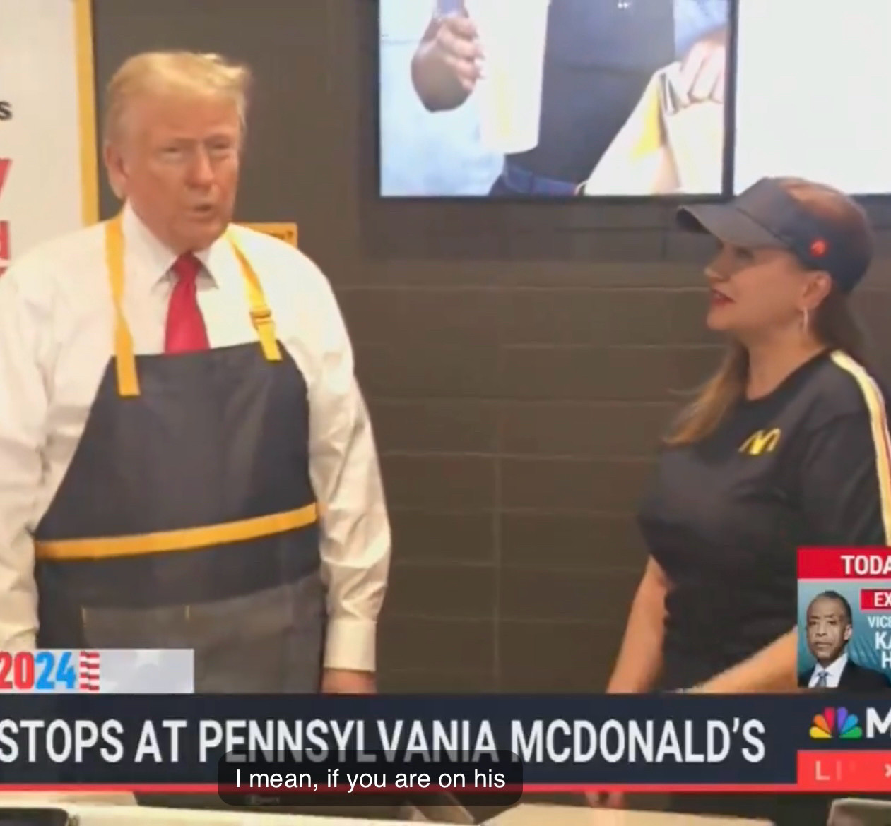 Trump lumbers around a Pennsylvania McDonalds with his red tie hiding under a Mickey D's apron. 