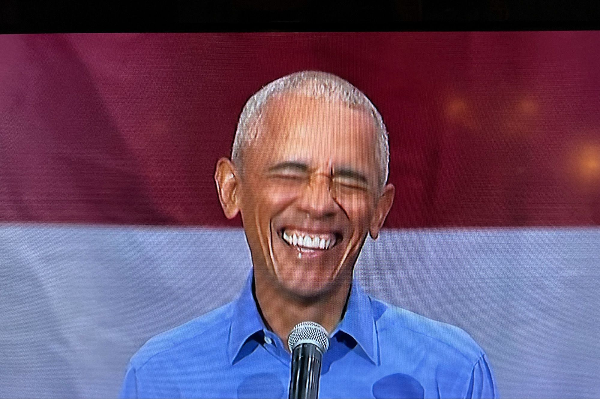 Obama laughing broadly