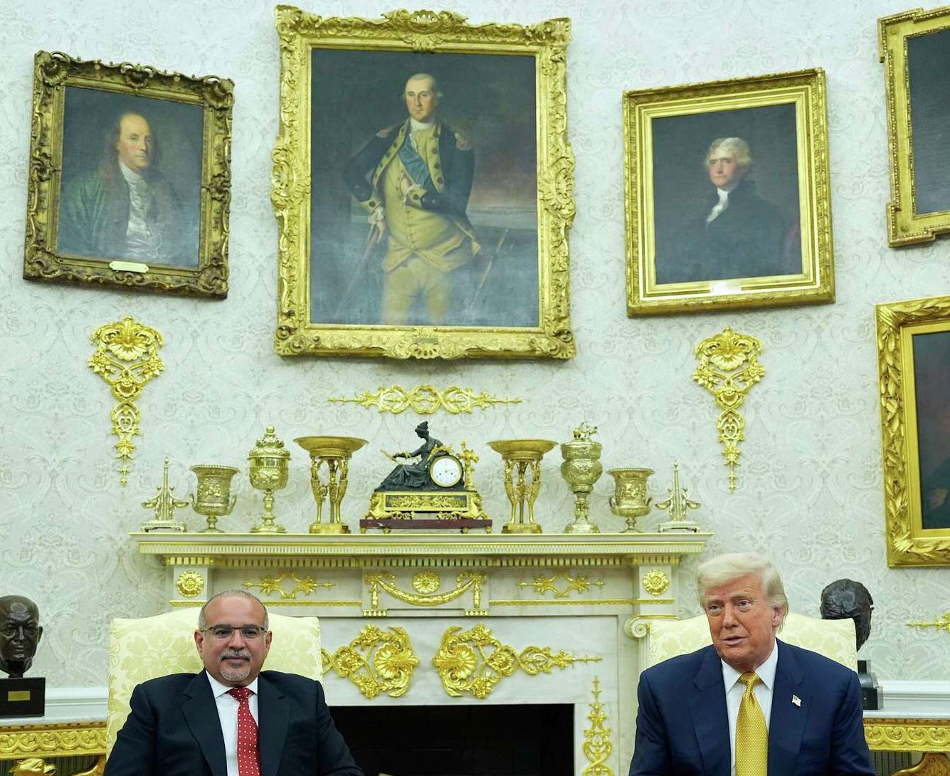 A more recent photo shows the jumbled mantle now has nine gold objets, there are now random gold embellishments on the wall itself and also gold tables and the mantle itself is now more gold paint than not. 