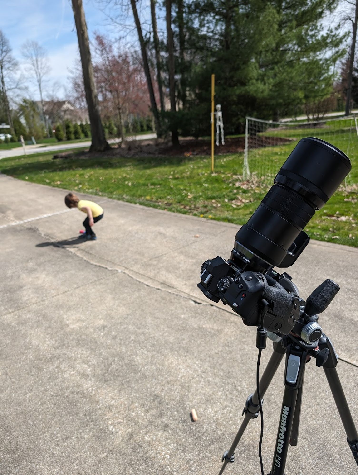 My camera in the foreground with a huge lens and my son Sebastian in the background