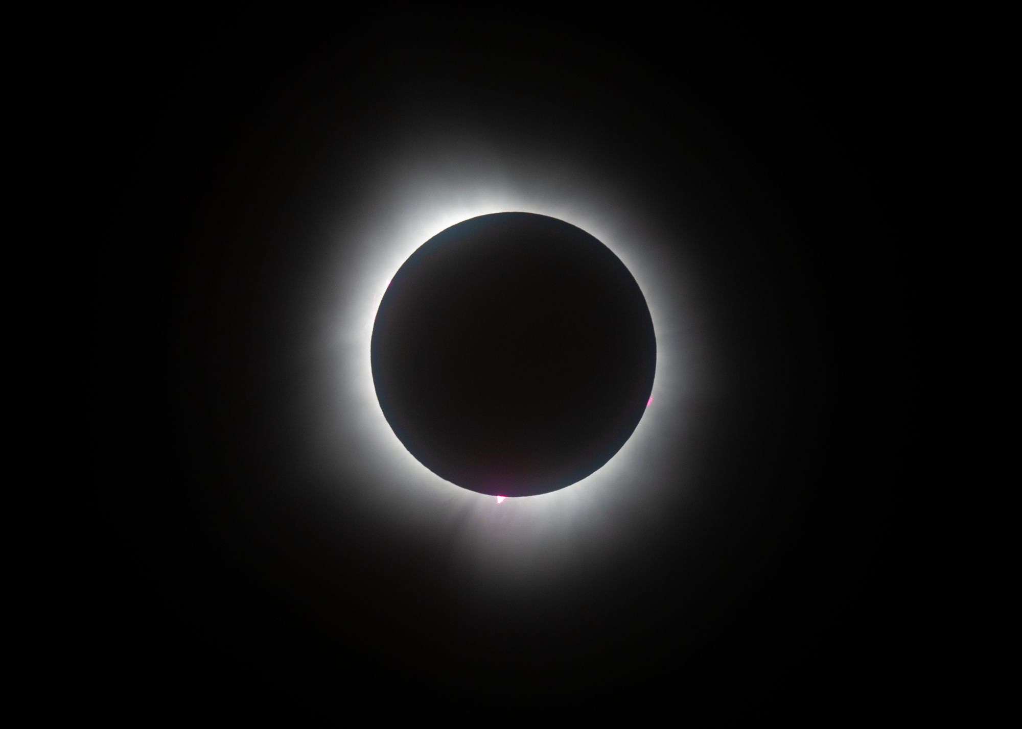 Eclipse at totality showing corona and solar flares