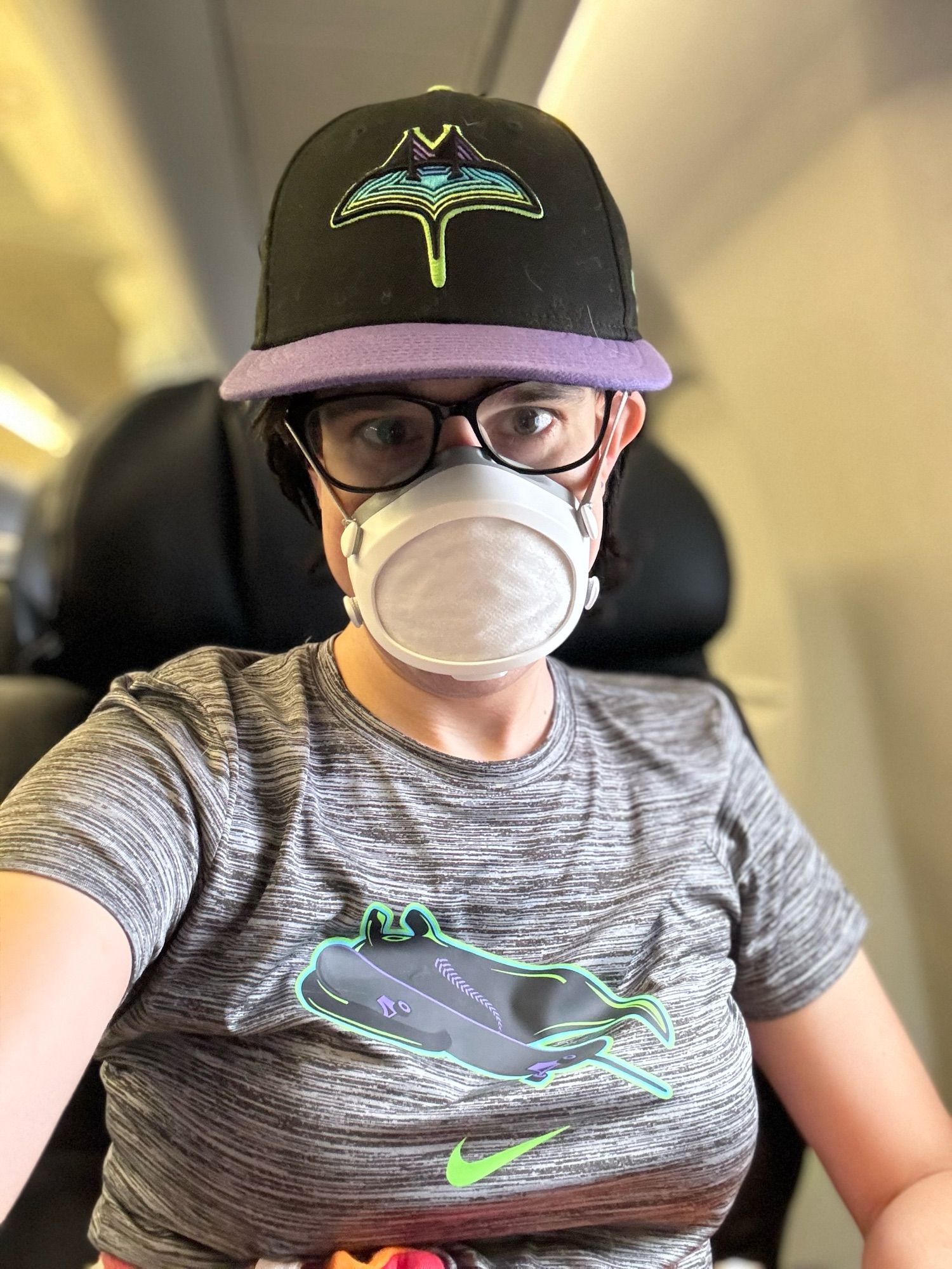 selfie of the author in first class on an Alaska/Horizon E175 wearing a Tampa Bay Rays City Connect hat and t-shirt