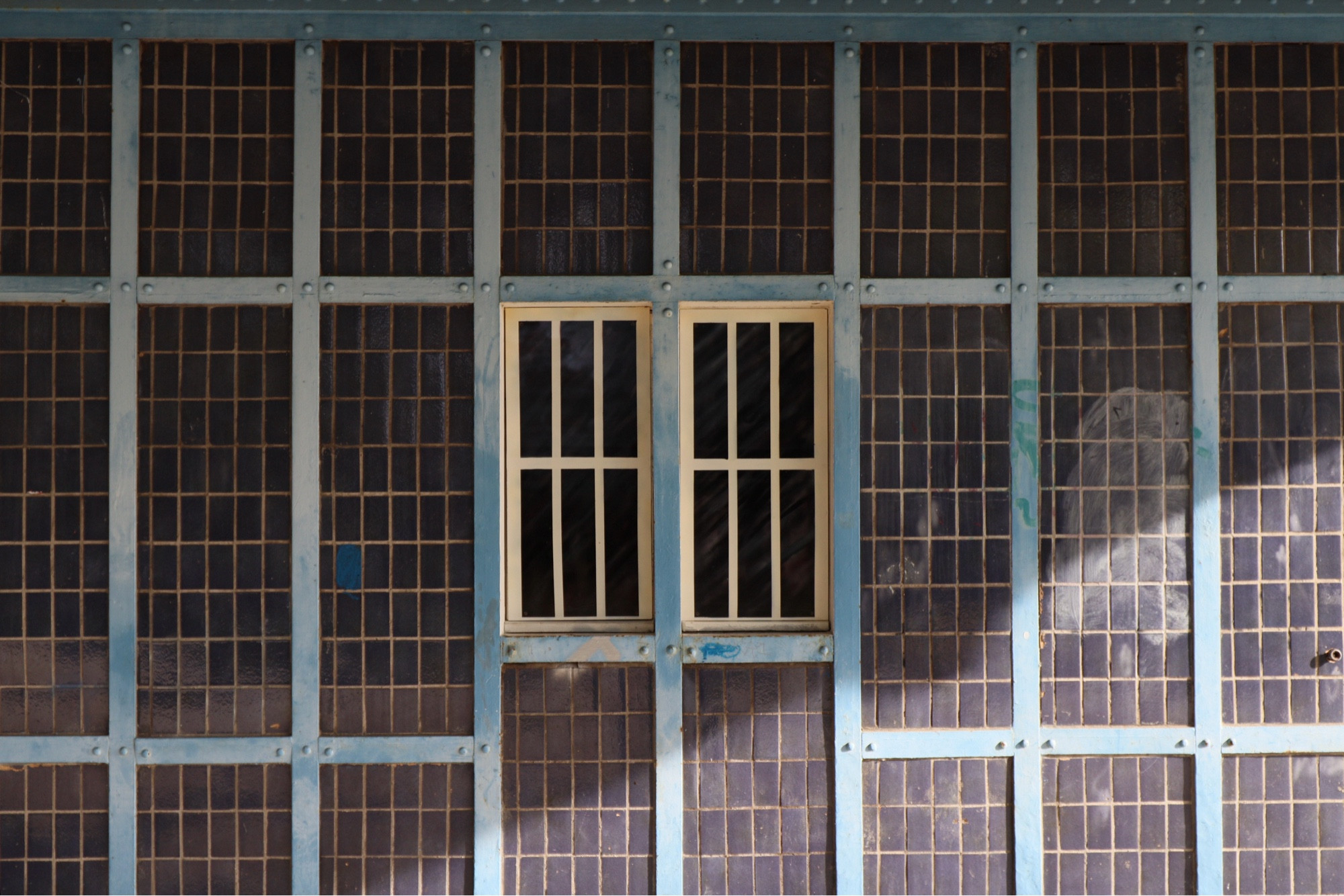 Same ironwork and tiles, but two windows and the sunlight cuts diagonally across the