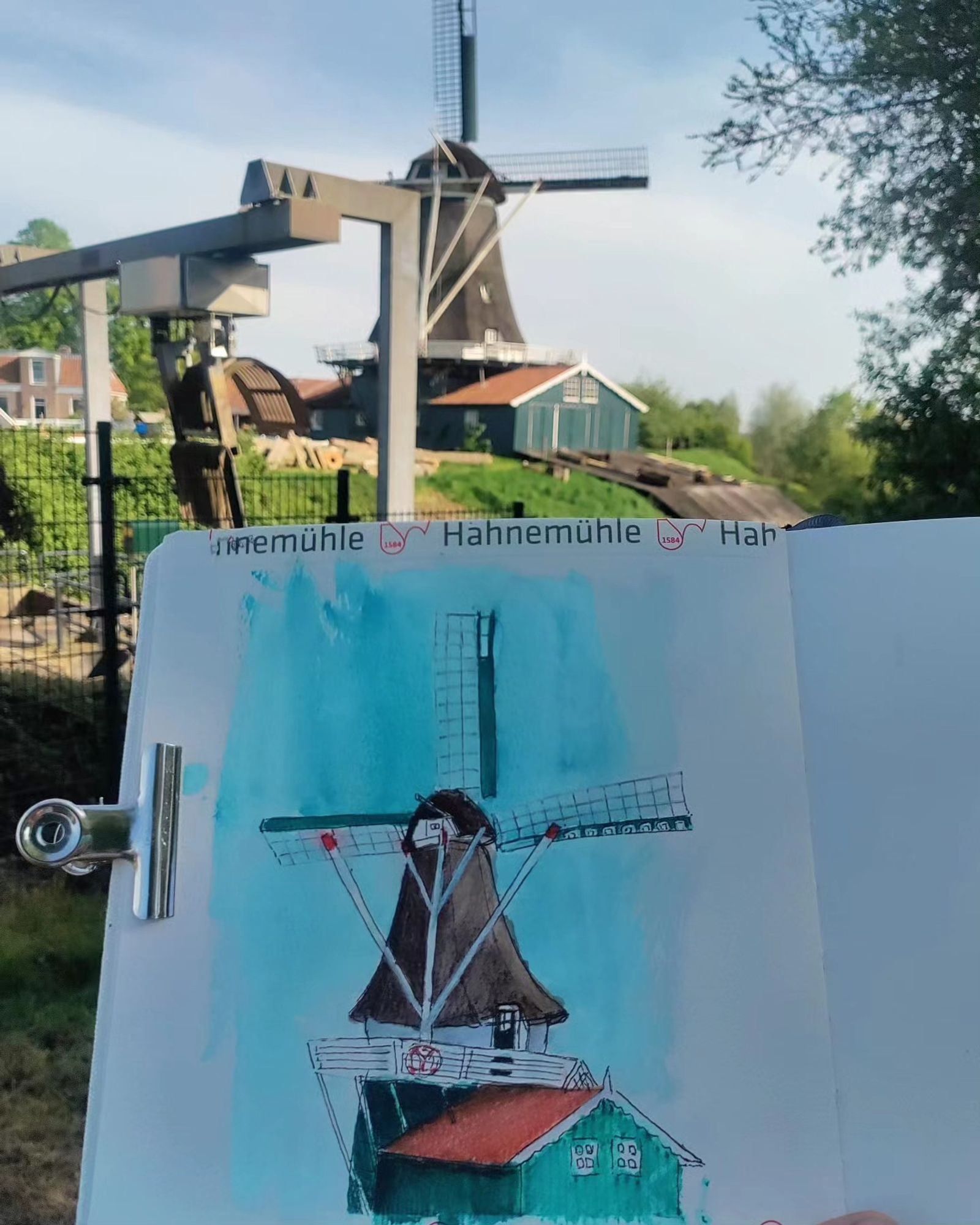 Bolwerksmolen windmill with watercolors and ink in front of the real thing