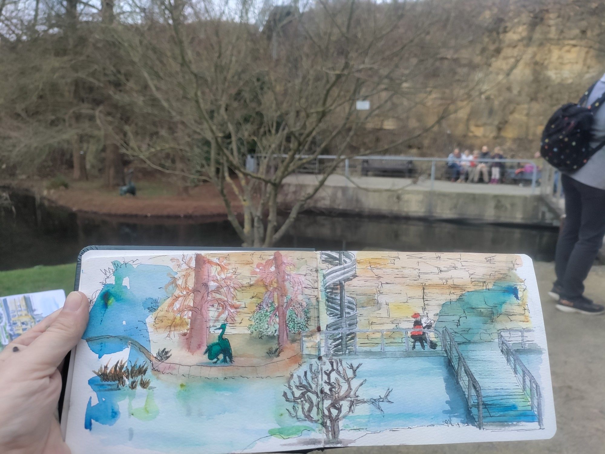 Watercolor & ink sketch in the botanical garden of the shoreline, spiral staircase + bridge over a lake