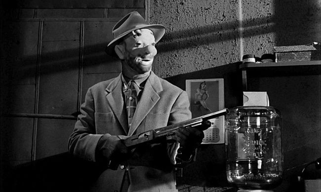 The Killing (1956) dir. Stanley Kubrick
An armed man in a rubber mask.