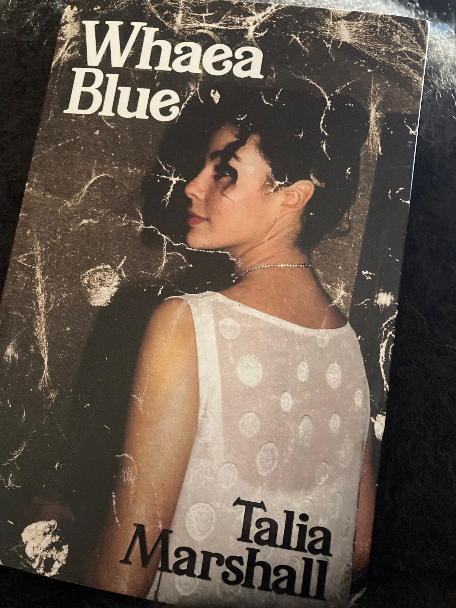 Front cover of book Whaea Blue by Talia Marshall. Cover of book shows young Talia with white dress and hair up.