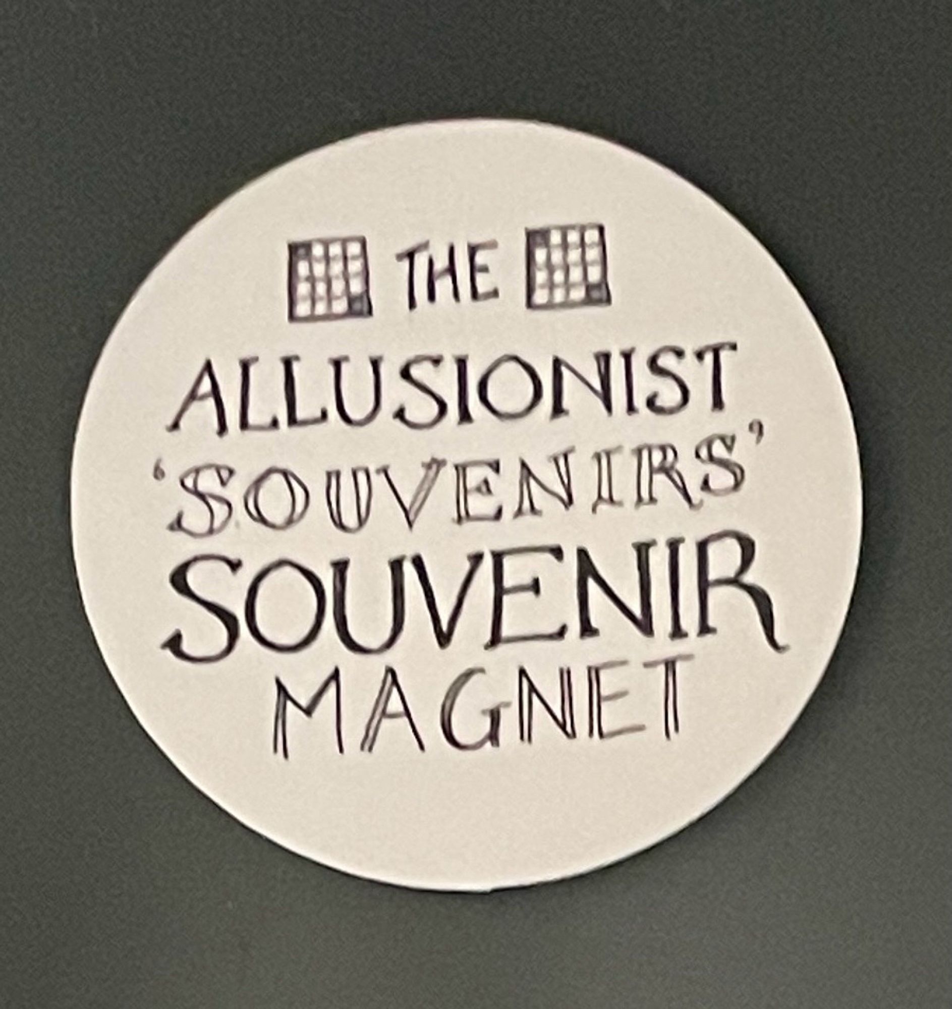 A white circular magnet that says The Allusionist souvenirs souvenir magnet