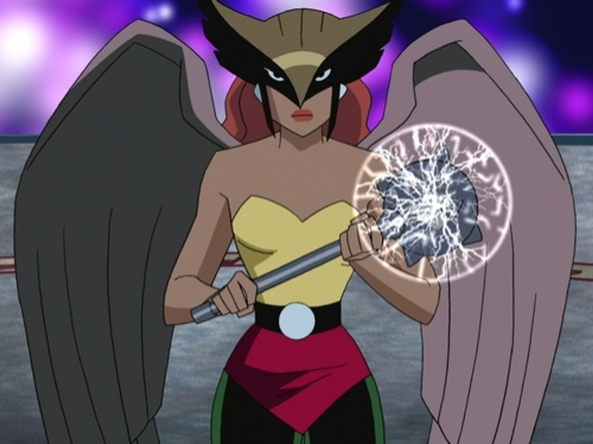 Image of superhero Hawkgirl from an animated Justice League cartoon. The character is a red haired woman with a birds shaped mask, holding an electrified mace, and has two large bird wings.