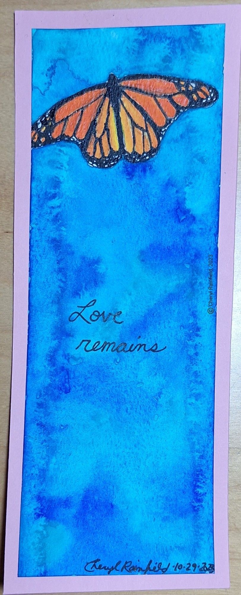 Watercolor painting with a lot of sky and a monarch butterfly at the top, words say Love remains. By Cheryl Rainfield