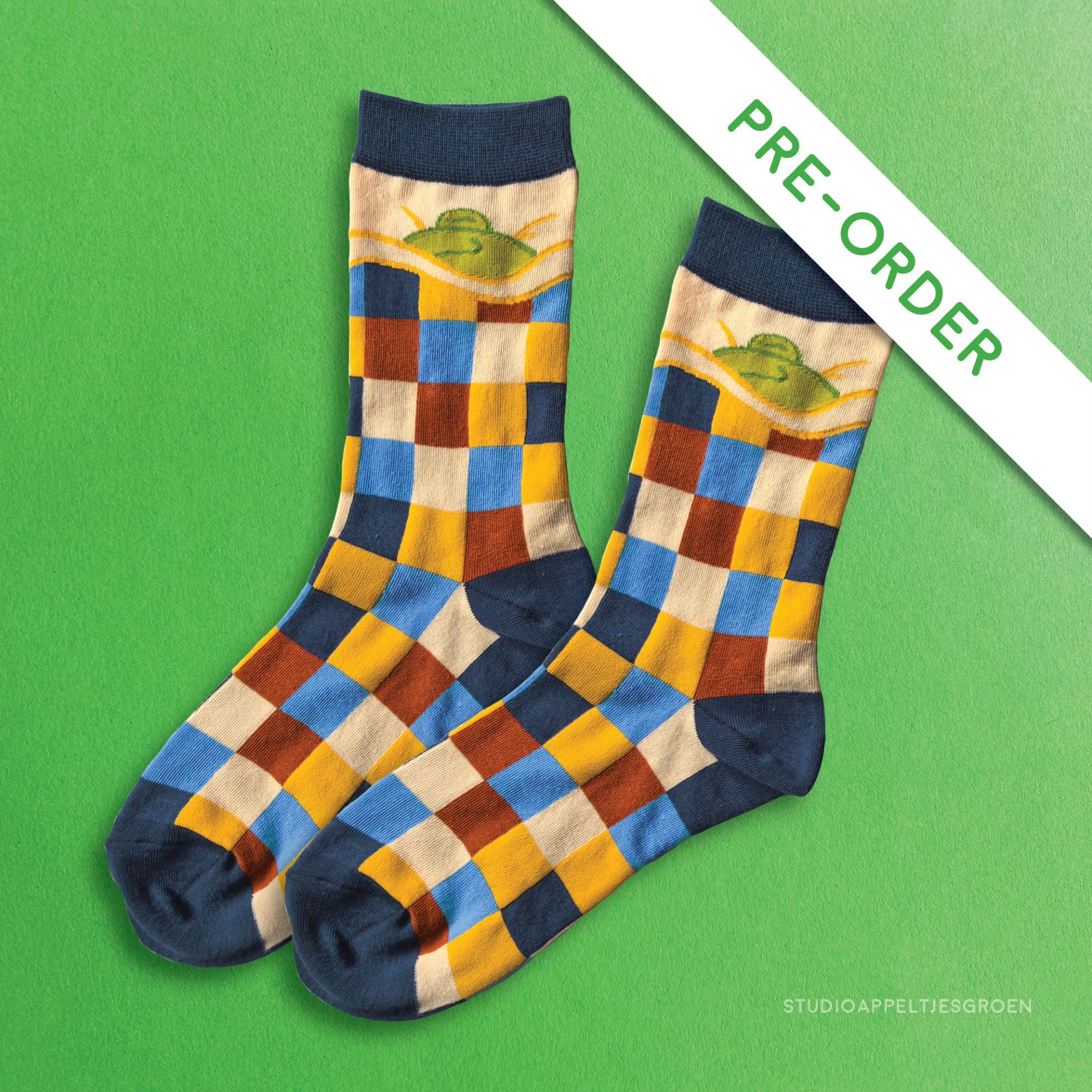 Dark blue socks with a checkered pattern and a sleepy frog on top.