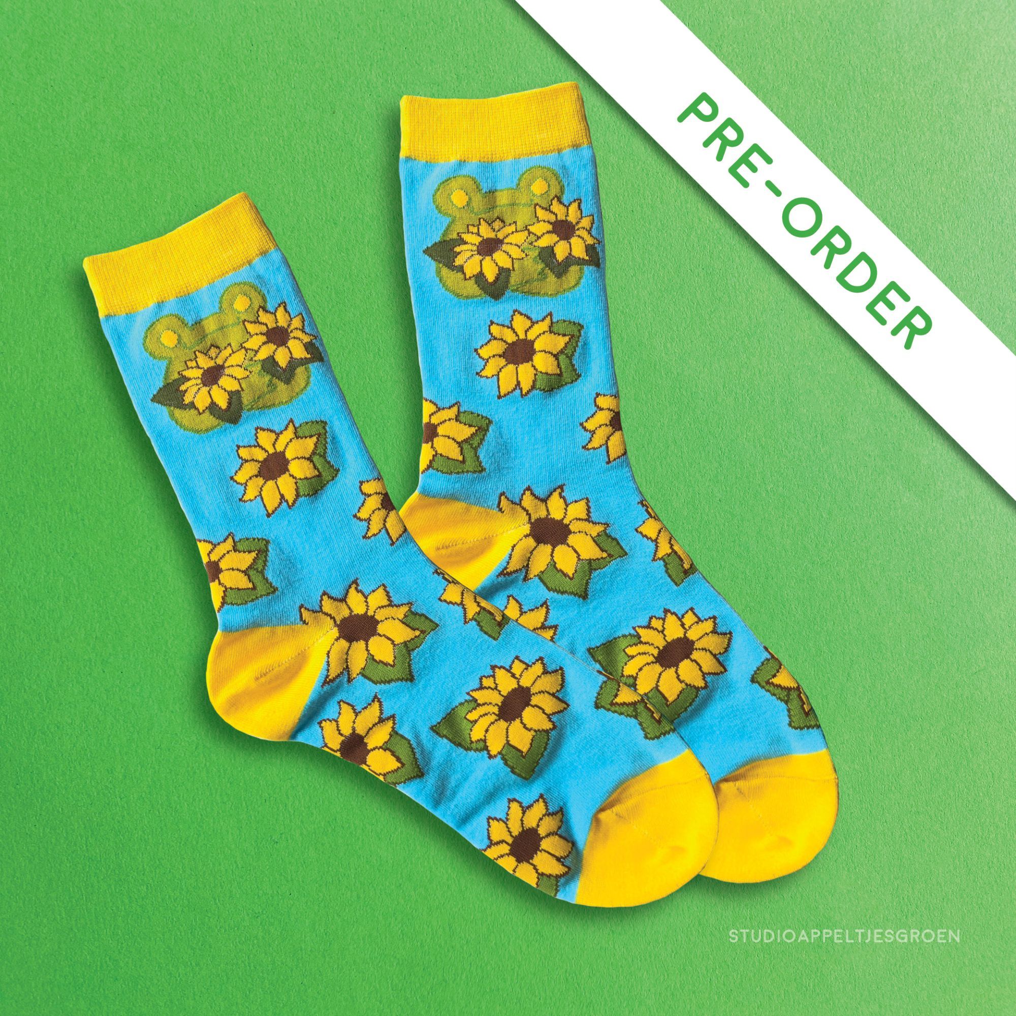 Yellow and bright blue socks with a sunflower pattern and a frog holding two sunflowers.