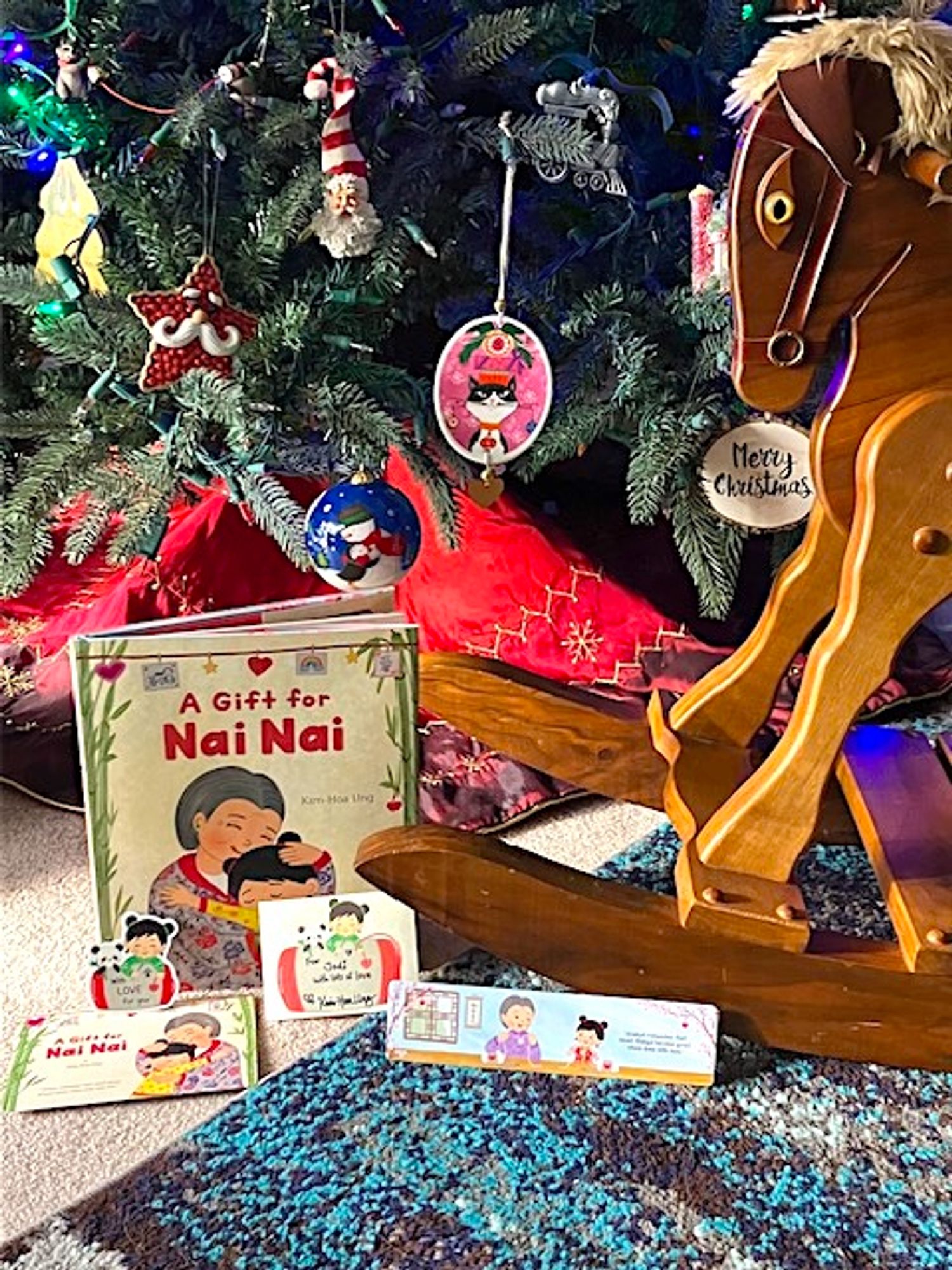 A Gift For Nai Nai book by Kim-Hoa Ung under Christmas tree with hobby horse.