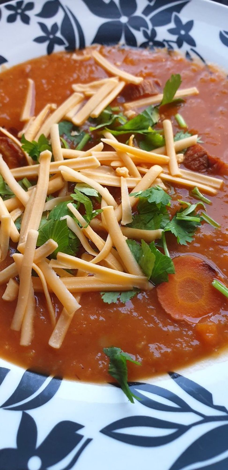 Roasted Carrot and Coriander soup, topped w/ chopped fresh coriander & grated "Vemondo" Cheddar 'cheese'