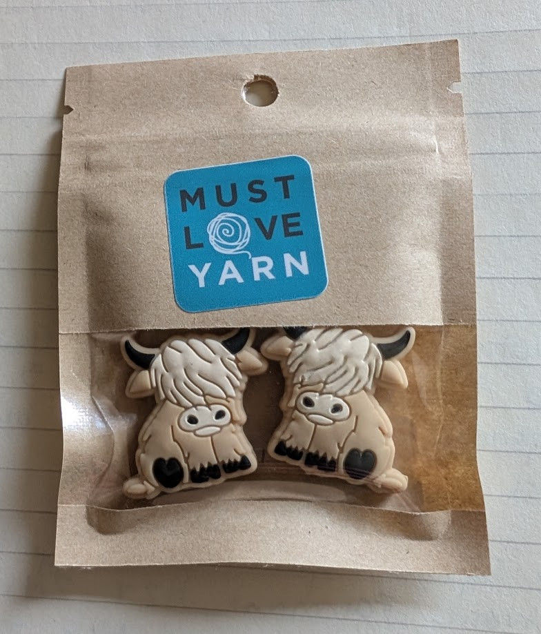 Needle point protectors shaped like Highland cows.