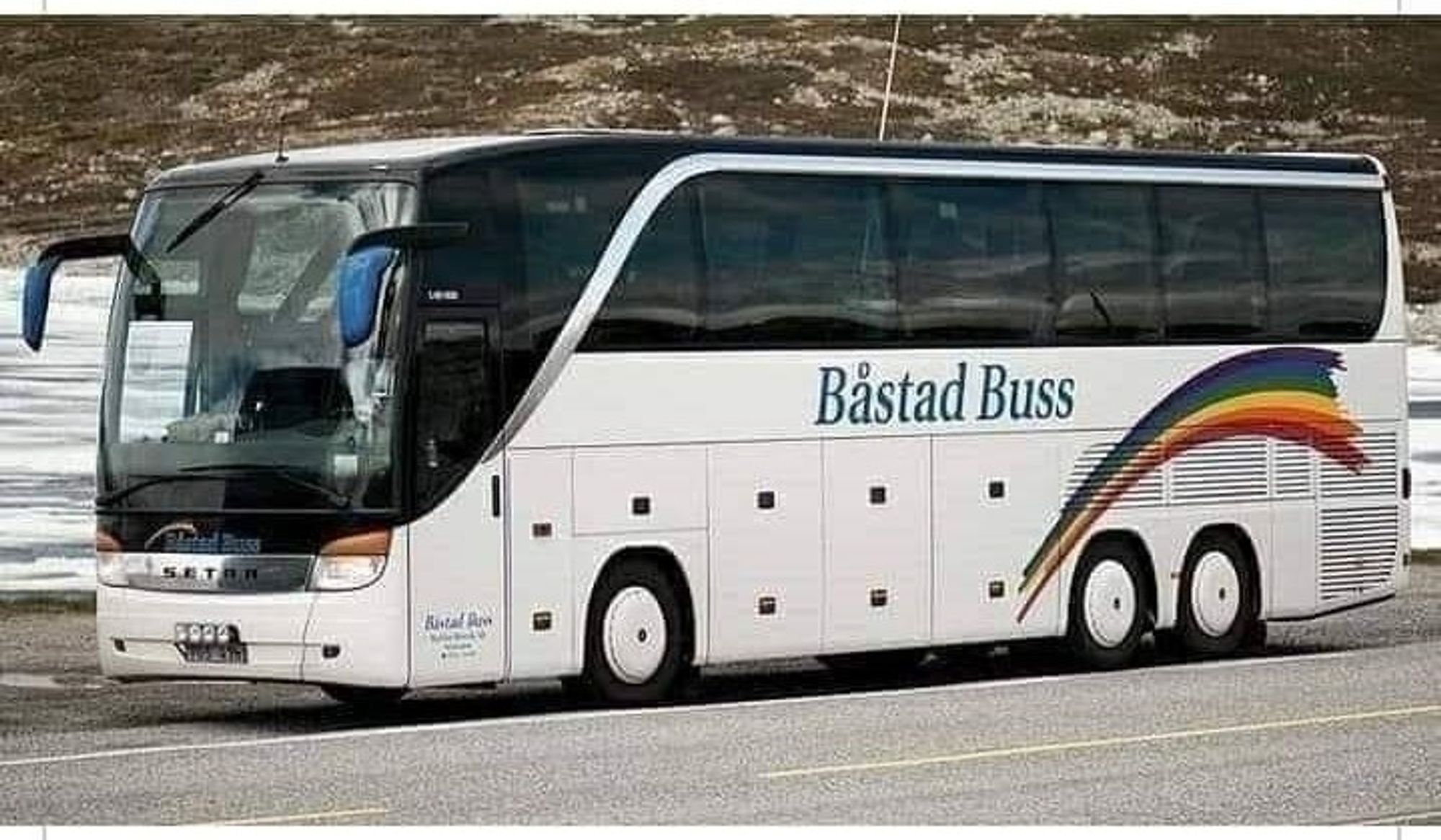 Image shows a coach/bus with the travel company shown on the side, and the name of the travel company is - Båstad Buss.