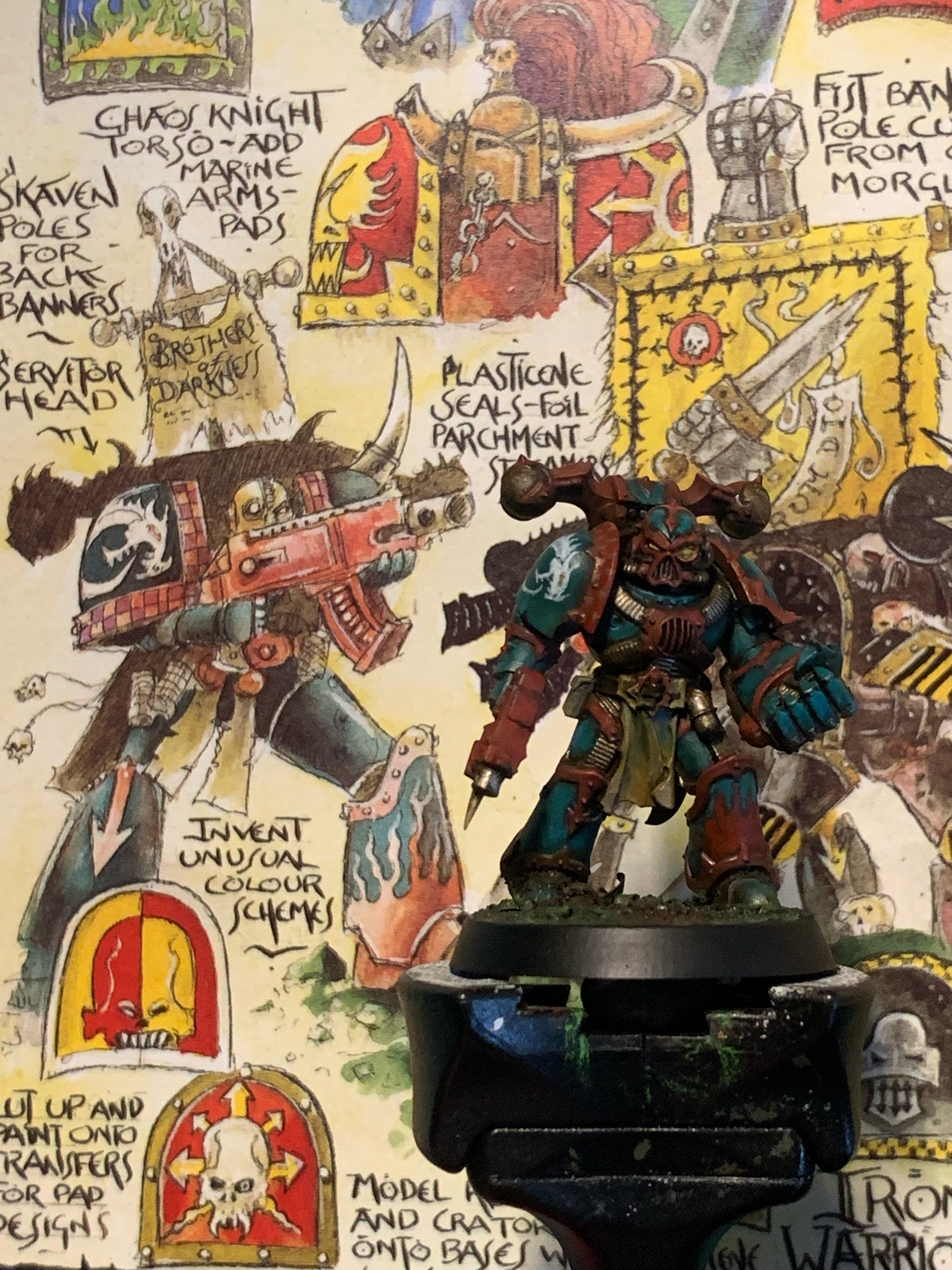 Chaos space marine next to the John Blanche artwork it was inspired by