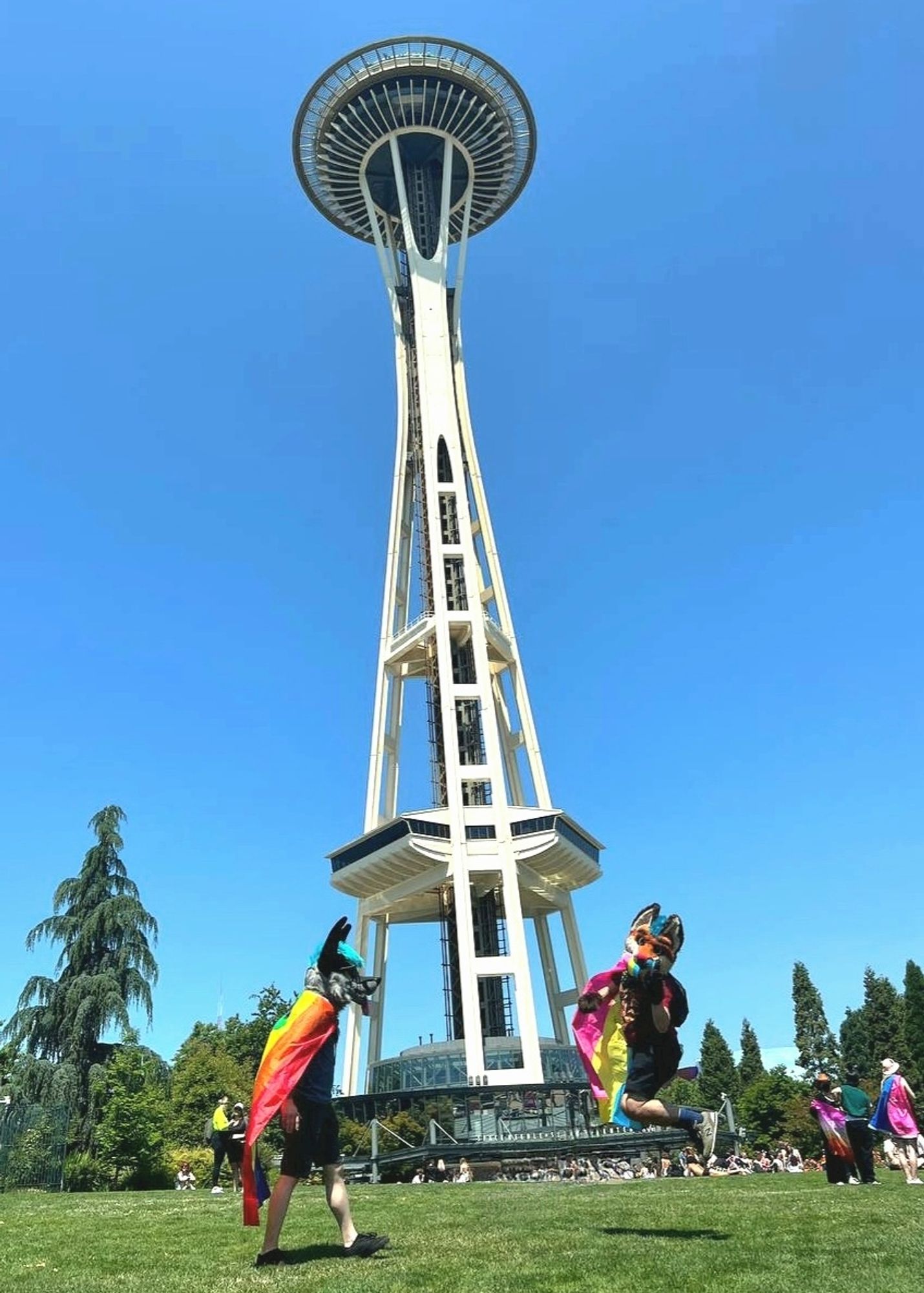 Me and Mosh in fursuit partials in front of space needle, and I'm jumping in the air