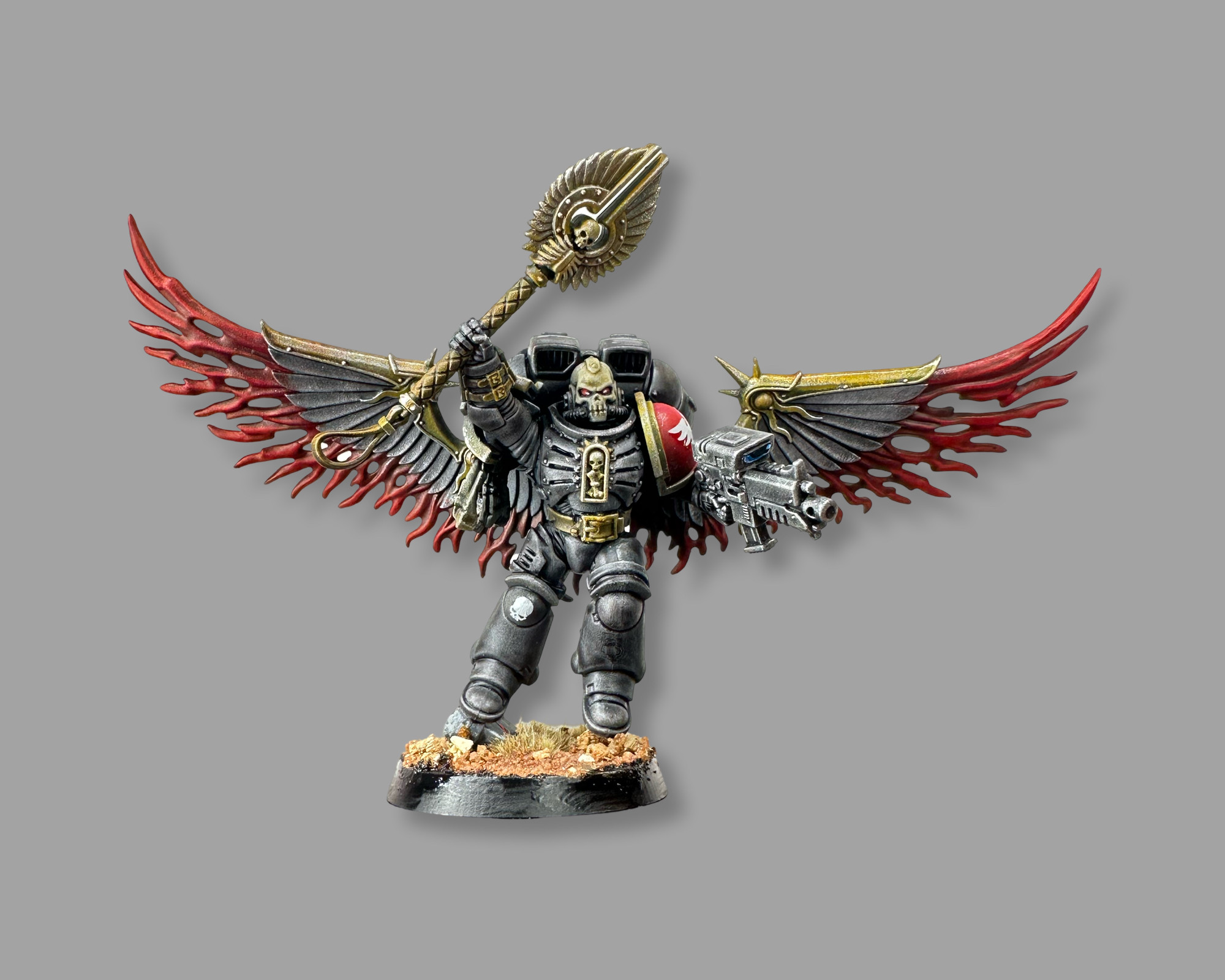 Kitbashed blood angels jump pack chaplain. Dark armour with gold trim. Crosius held aloft in one hand and a big gun in the other. He has stormcast prosecutor wings that look like they have blood flying out of them. Gross.