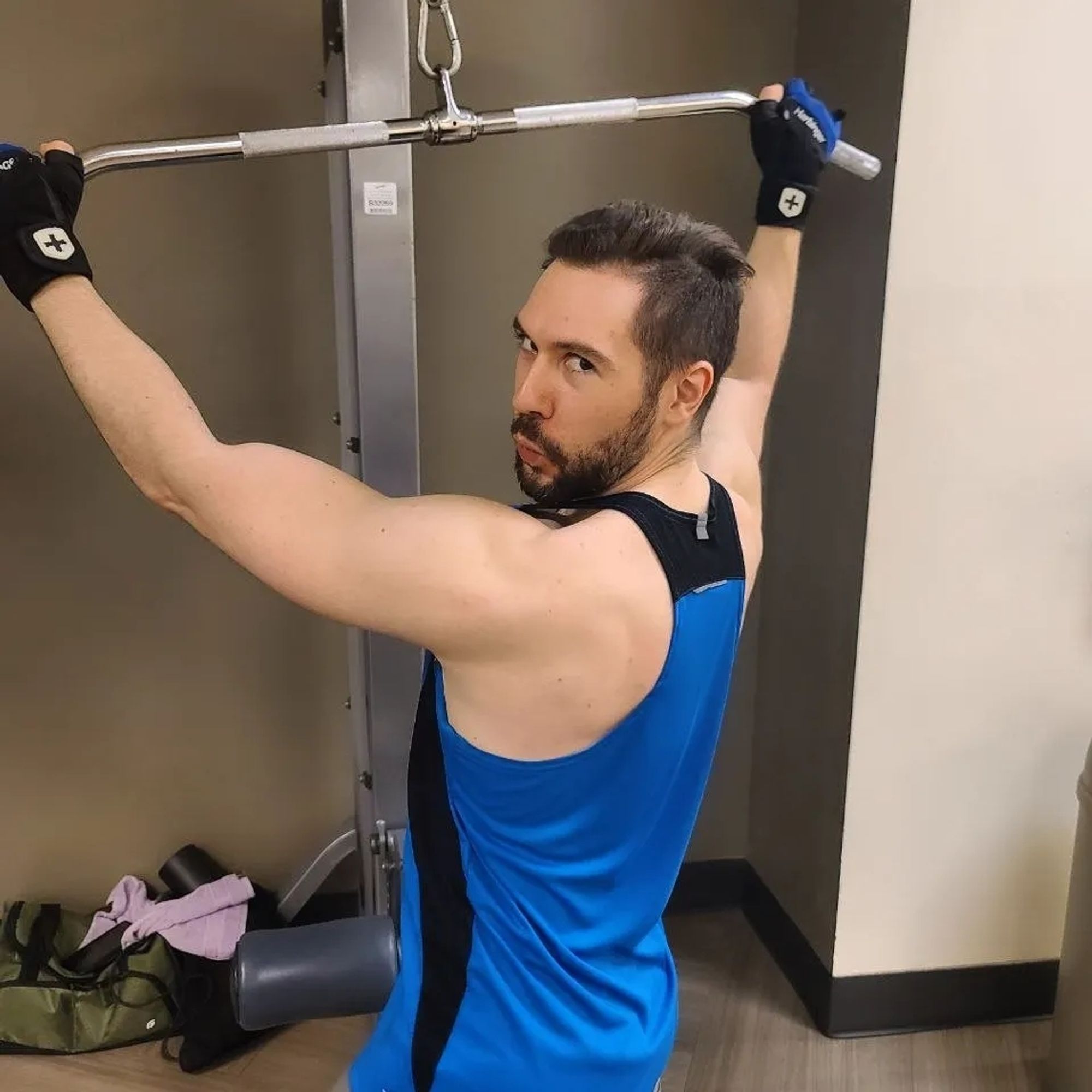 Man making a sassy face on the lat pulldown machine