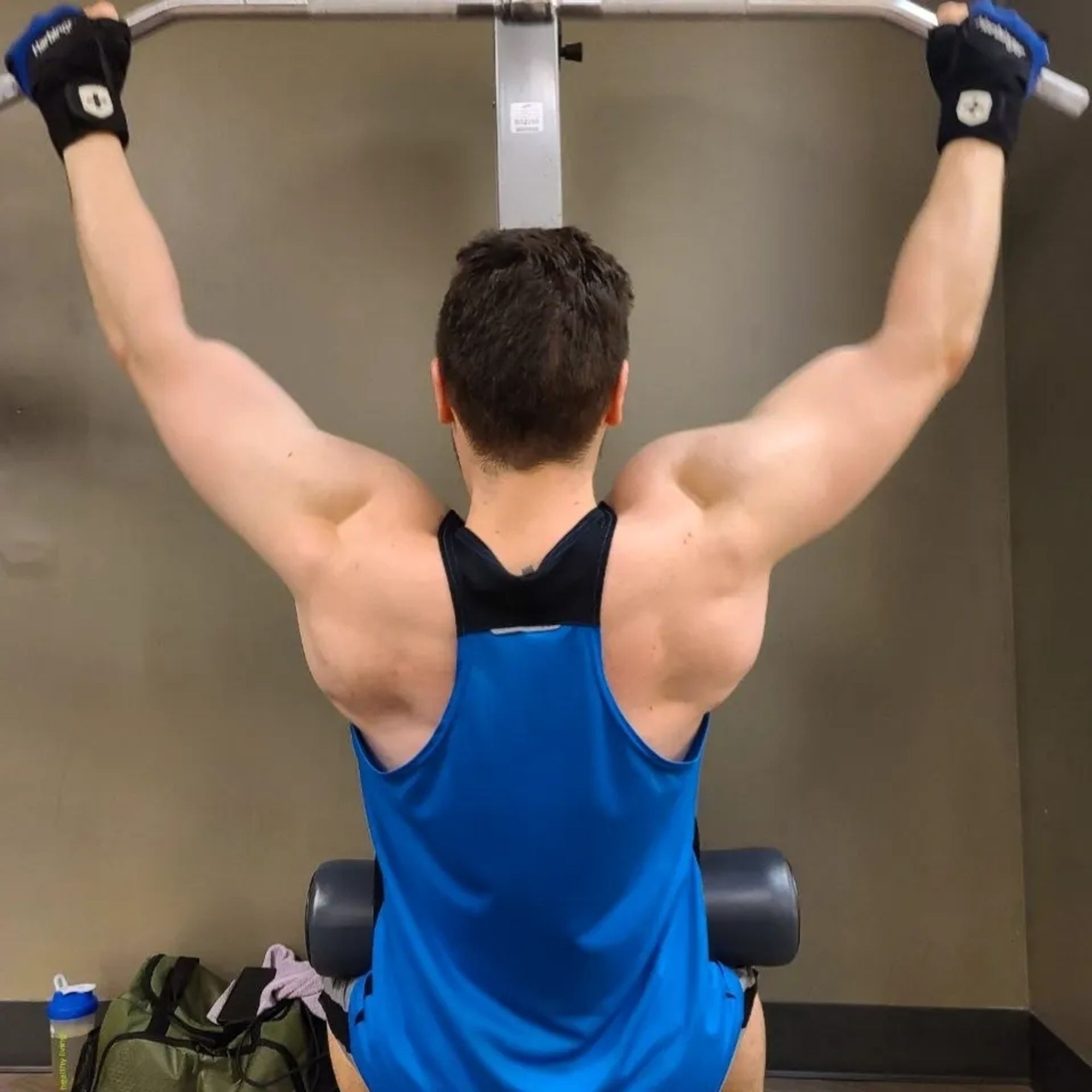 Man doing lat pulldowns (top of rep)