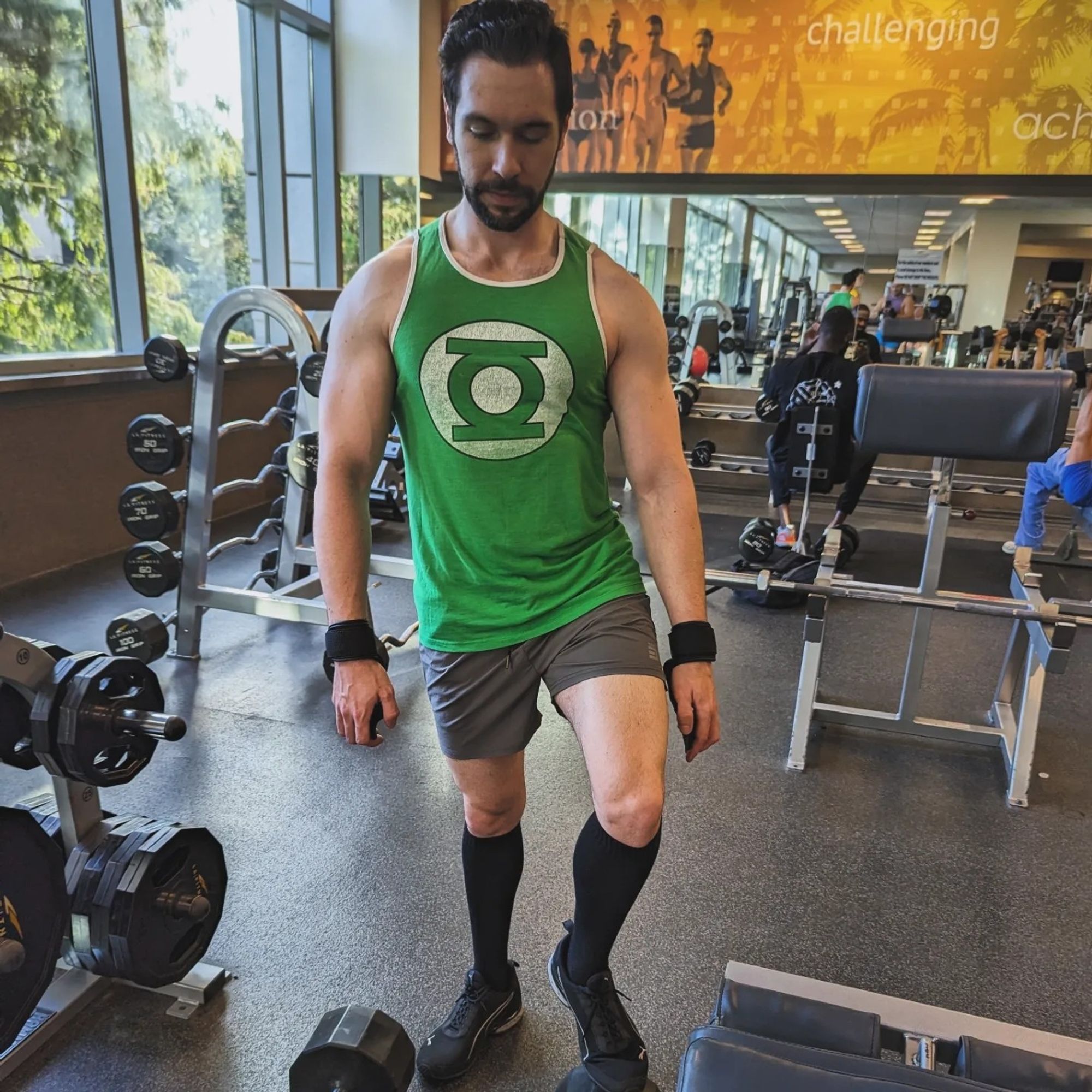 Man rolling dumbbells with his feet