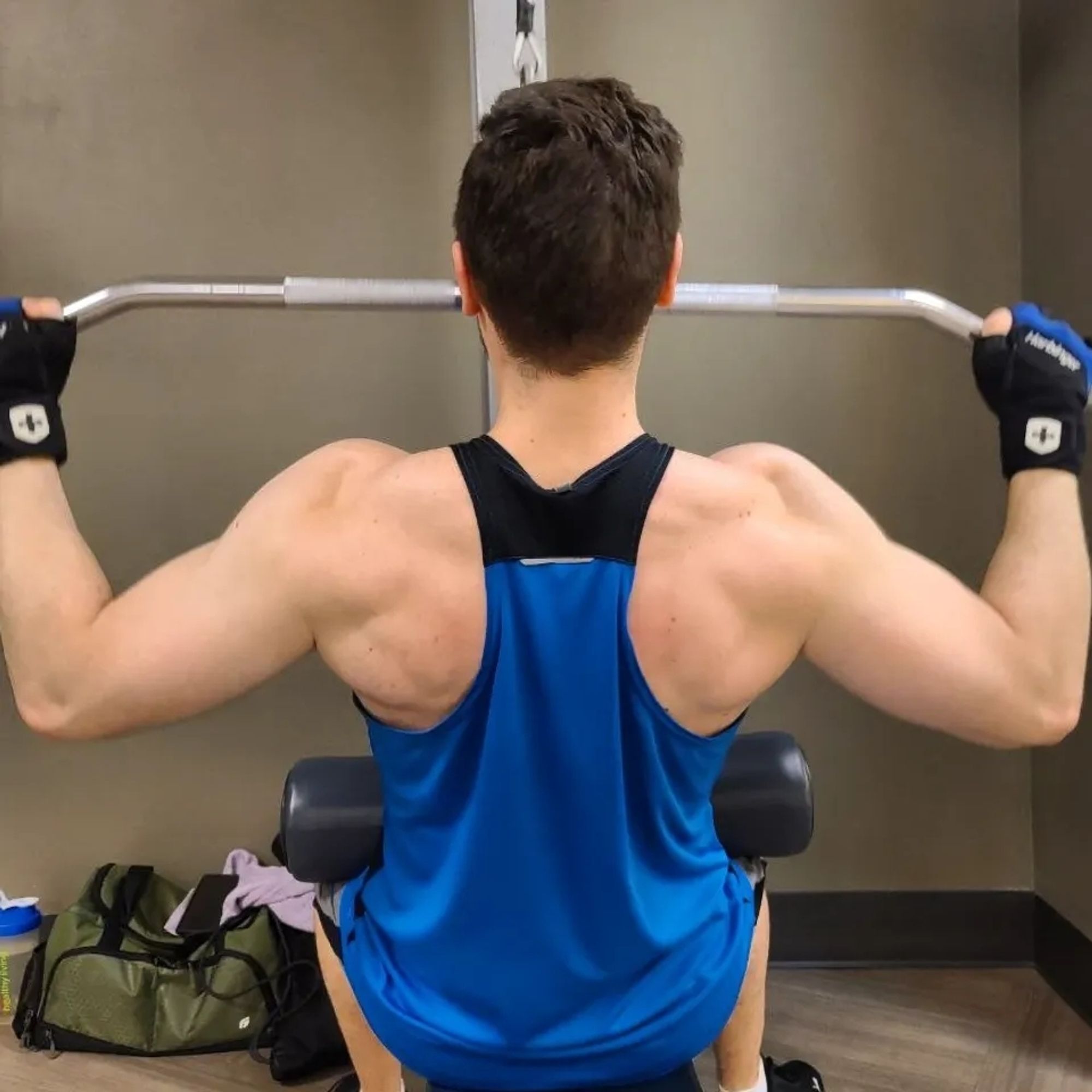 Man doing lat pulldowns (bottom of rep)