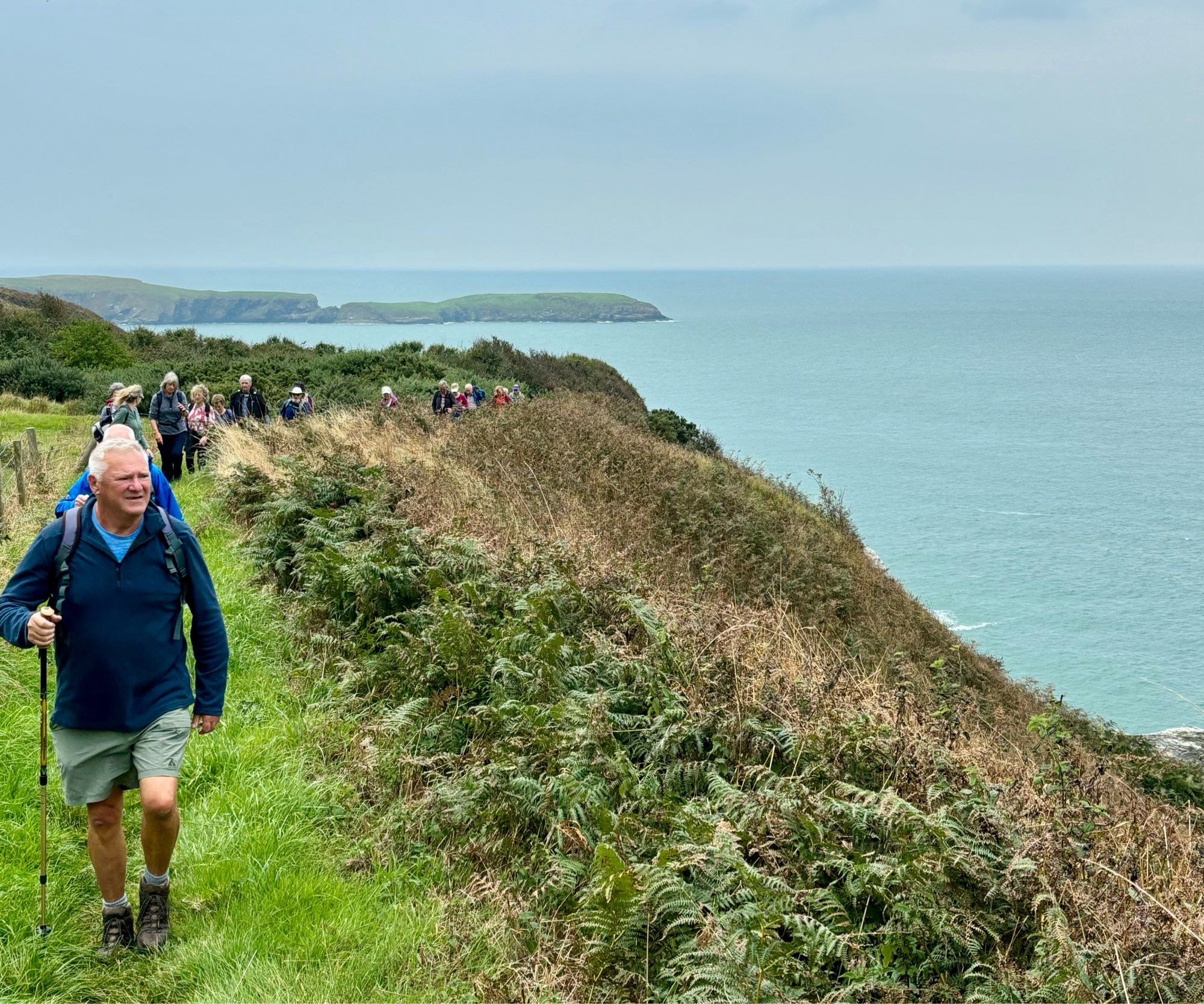 Walkers heading towards the Urdd along the coastpath.