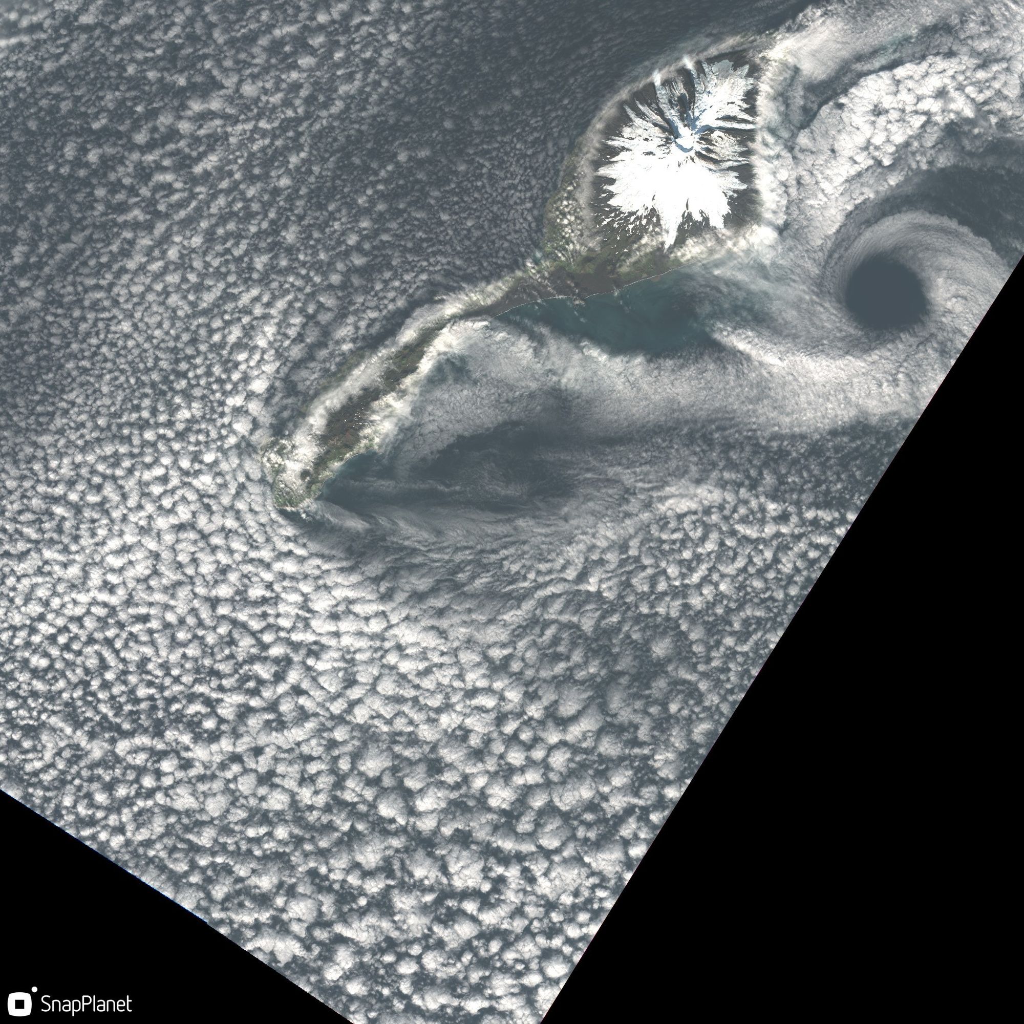 A Von Karman vortex appears downstream of Jan Mayen, picked out in the cloud patterns and captured by a satellite image from sentinel 2