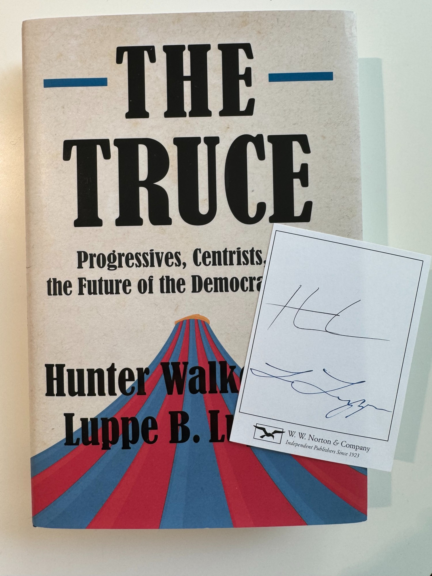 A book called THE TRUCE: PROGRESSIVES, CENTRISTS, AND THE FUTURE OF THE DEMOCRATIC PARTY by Hunter Walker and Luppe B. Luppen, along with a signed bookplate by the authors