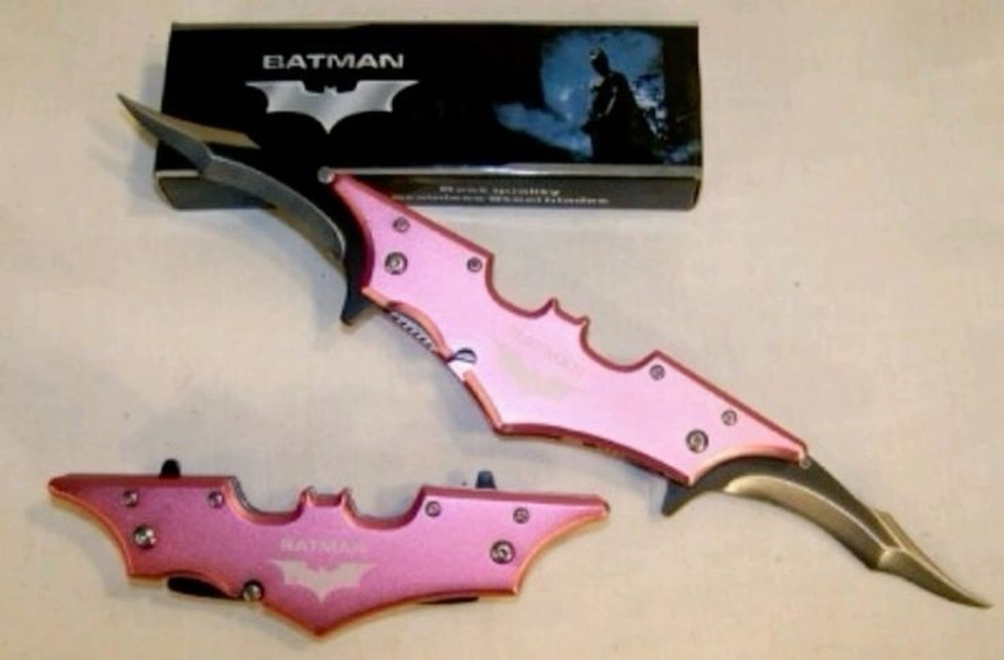 pink double sided knife shaped like the batman signal