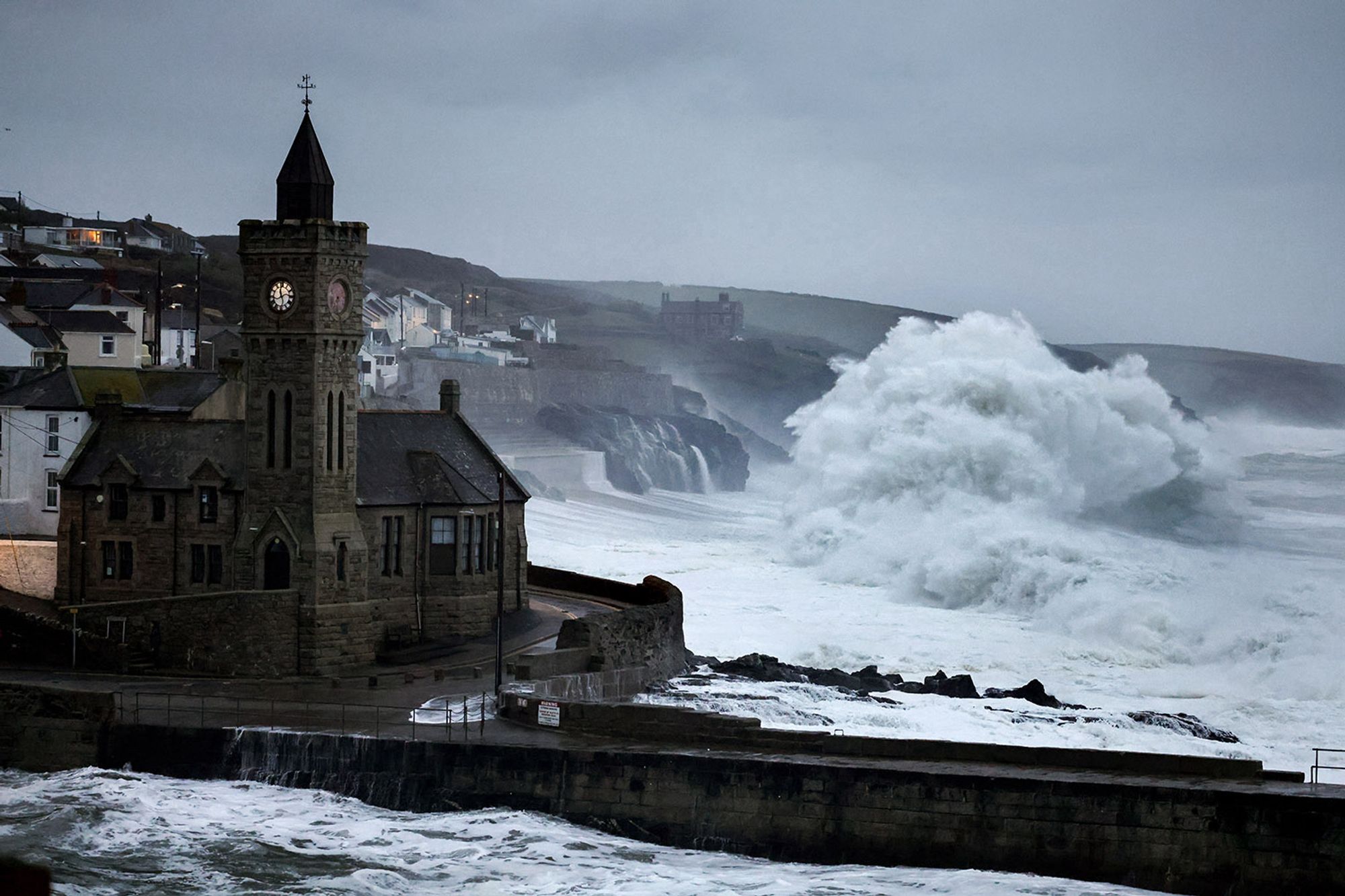 Porthleven in a storm with high waves crashing onto the beach