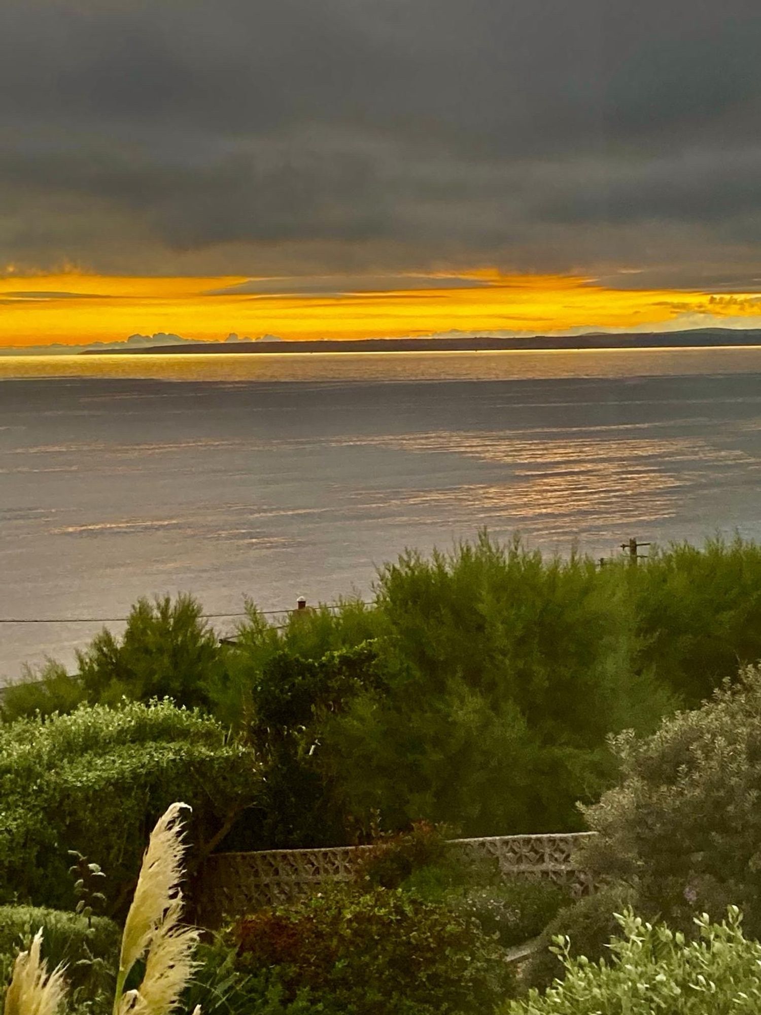 A view across Mounts Bay towards the setting sun